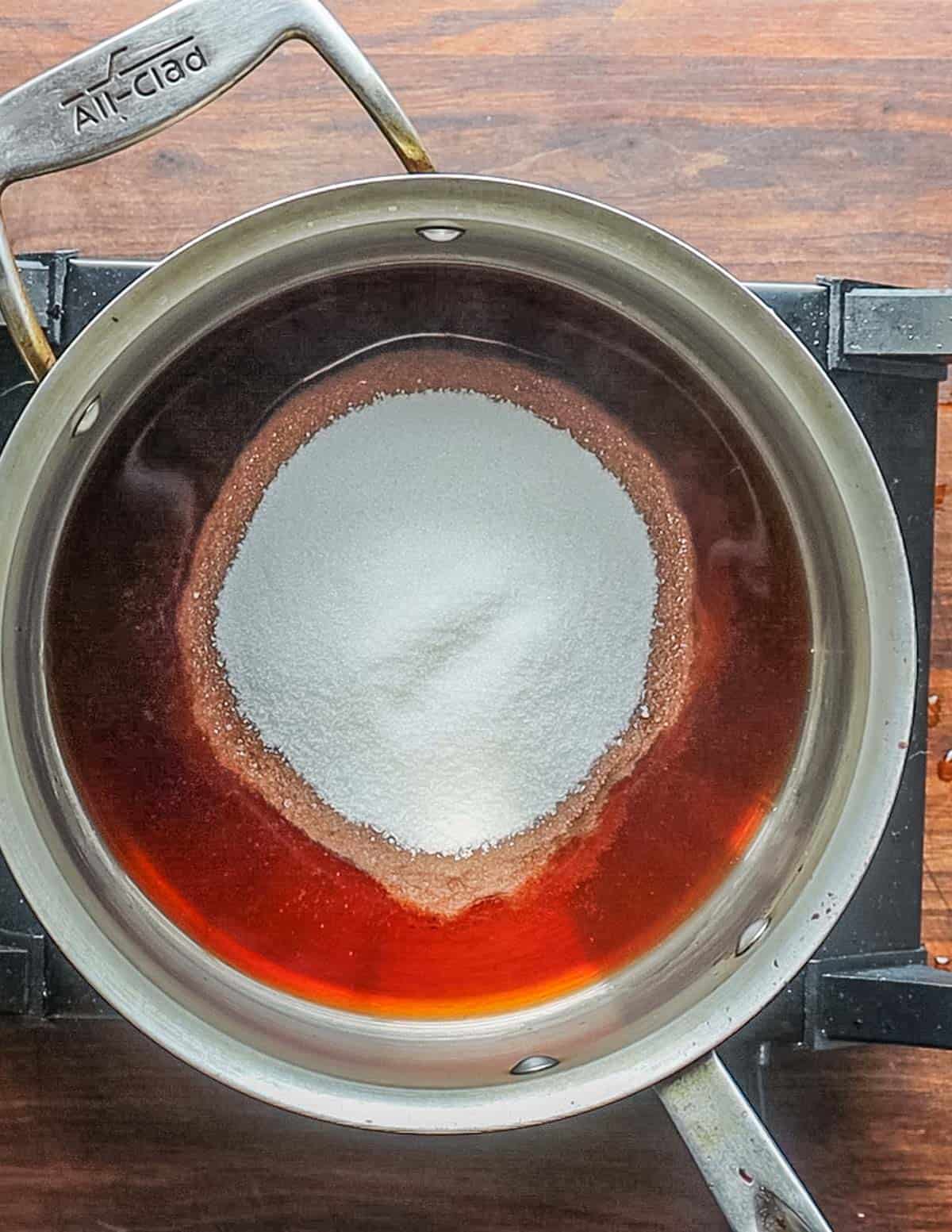 Cooking sugar and vinegar in a pot before making jam. 