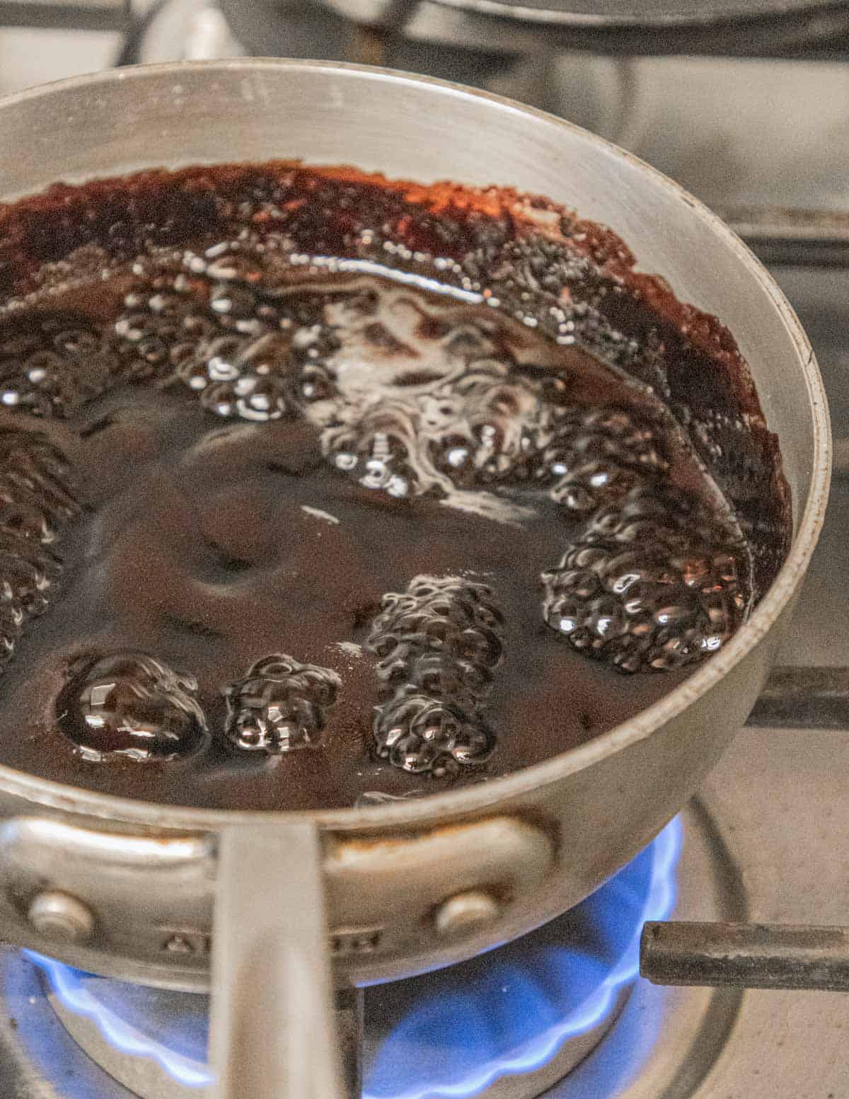 A small pot of boiling mulberry syrup. 