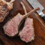 Perfectly cooked sous vide lamb chops sliced on a cutting board ready to serve.