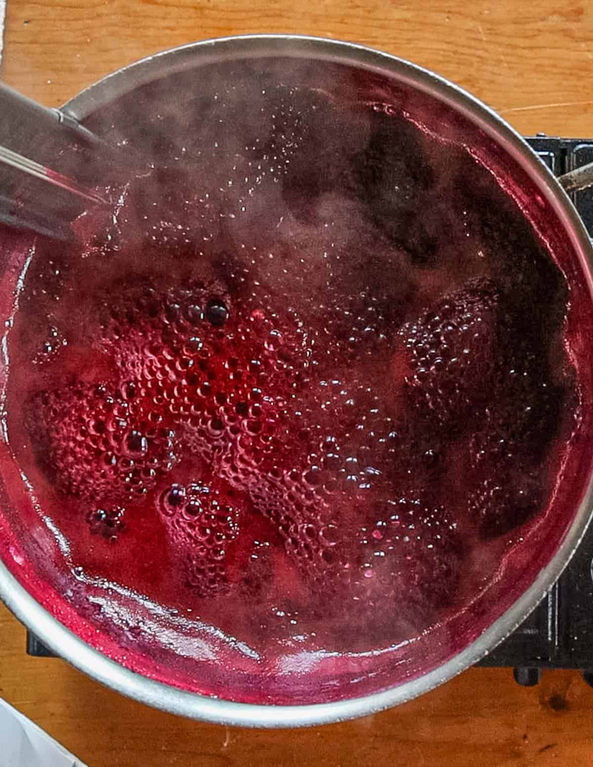 A pot of grape jelly boiling. 