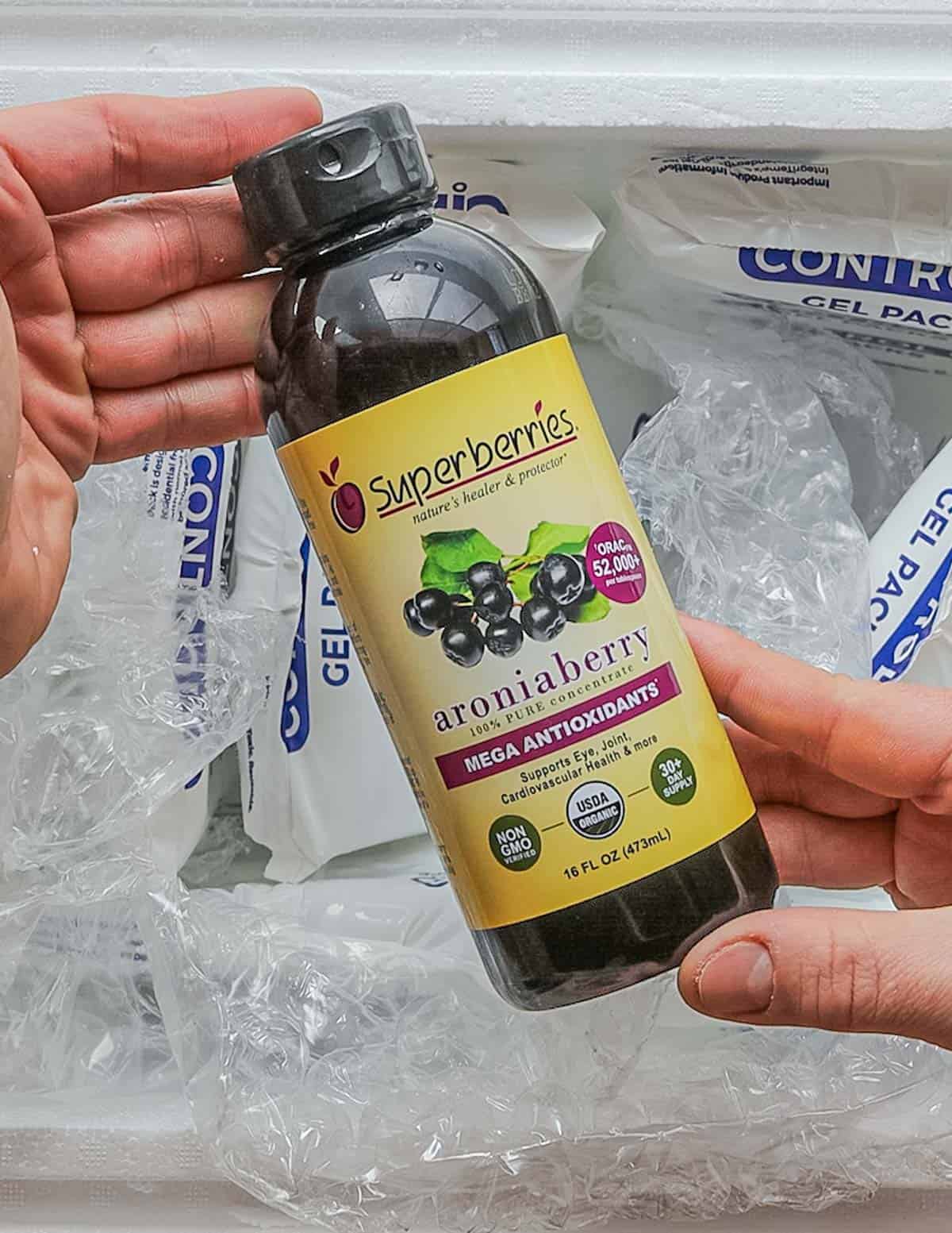Frozen aronia juice from superberries being removed from the box. 