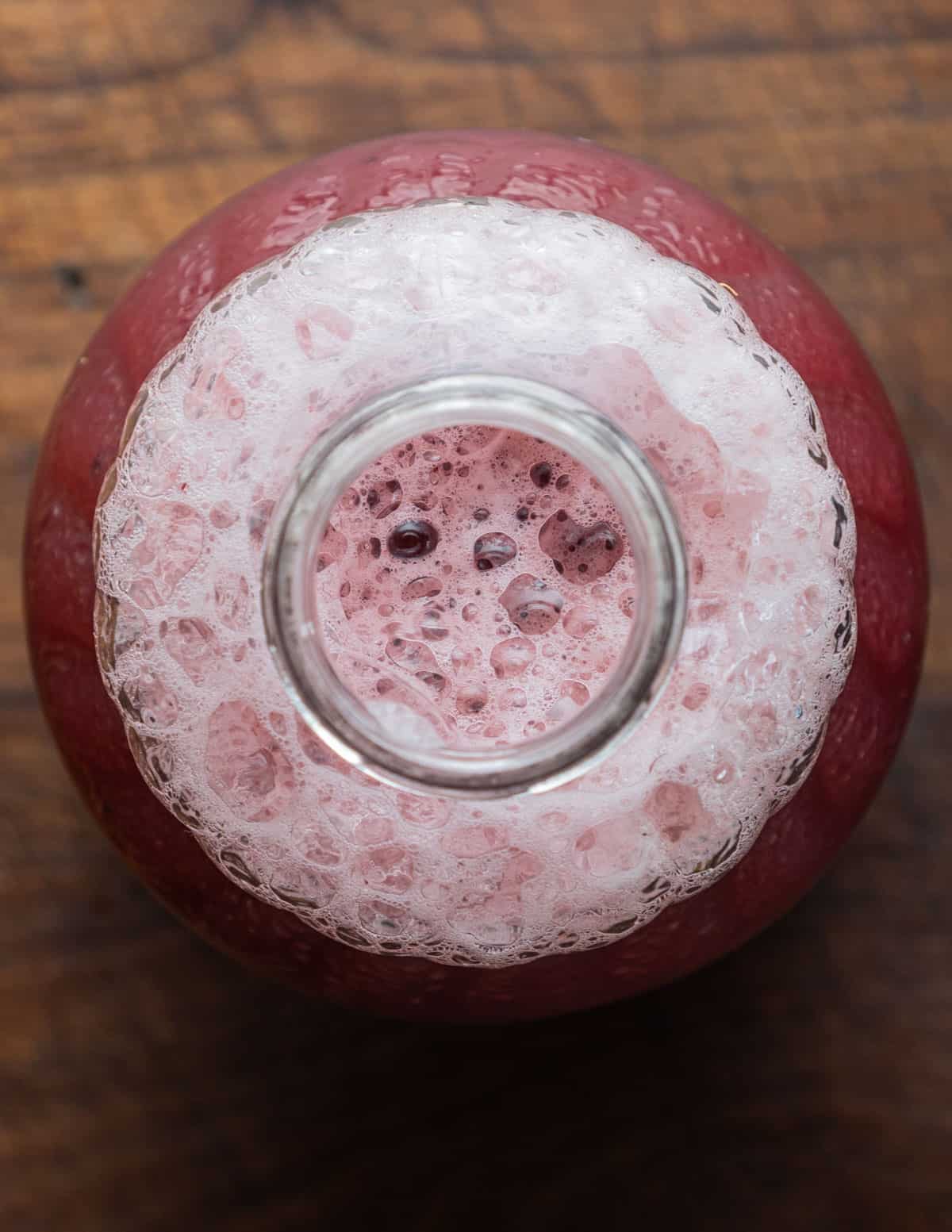 A close up image of a jar of chokeberry juice. 