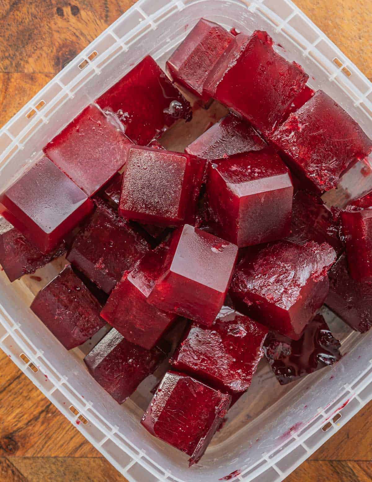 An ice cube tray filled with aronia berry juice cubes. 