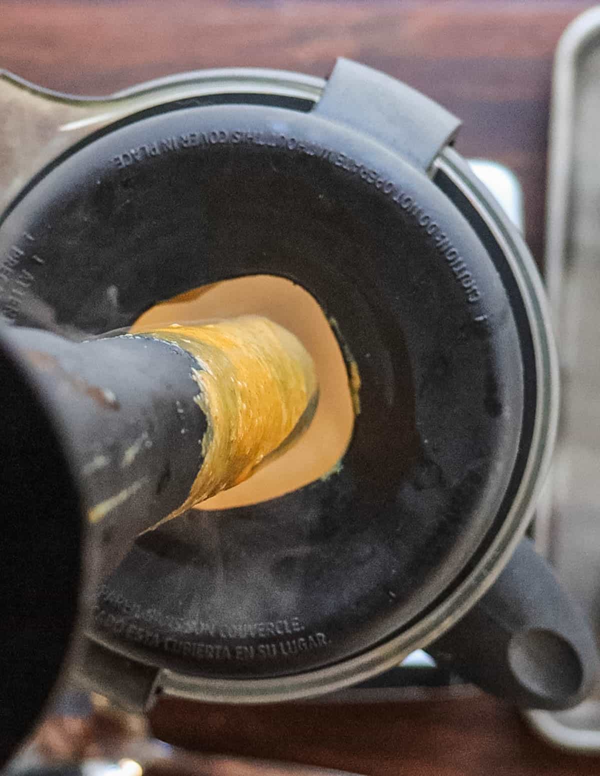 Pureeing mustard barbecue sauce in a blender. 