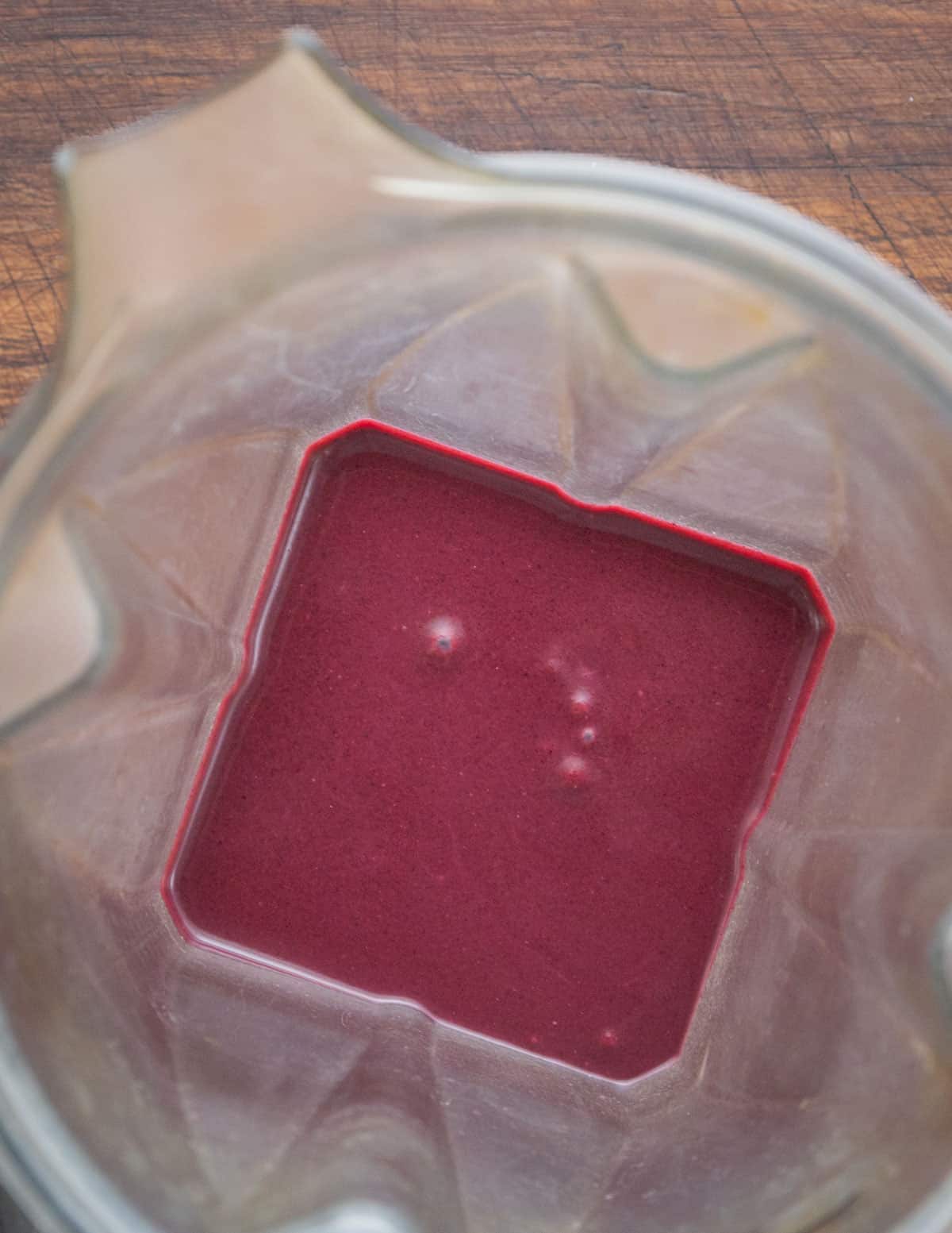 Pureeing a blueberry coulis sauce in a vitamix blender. 