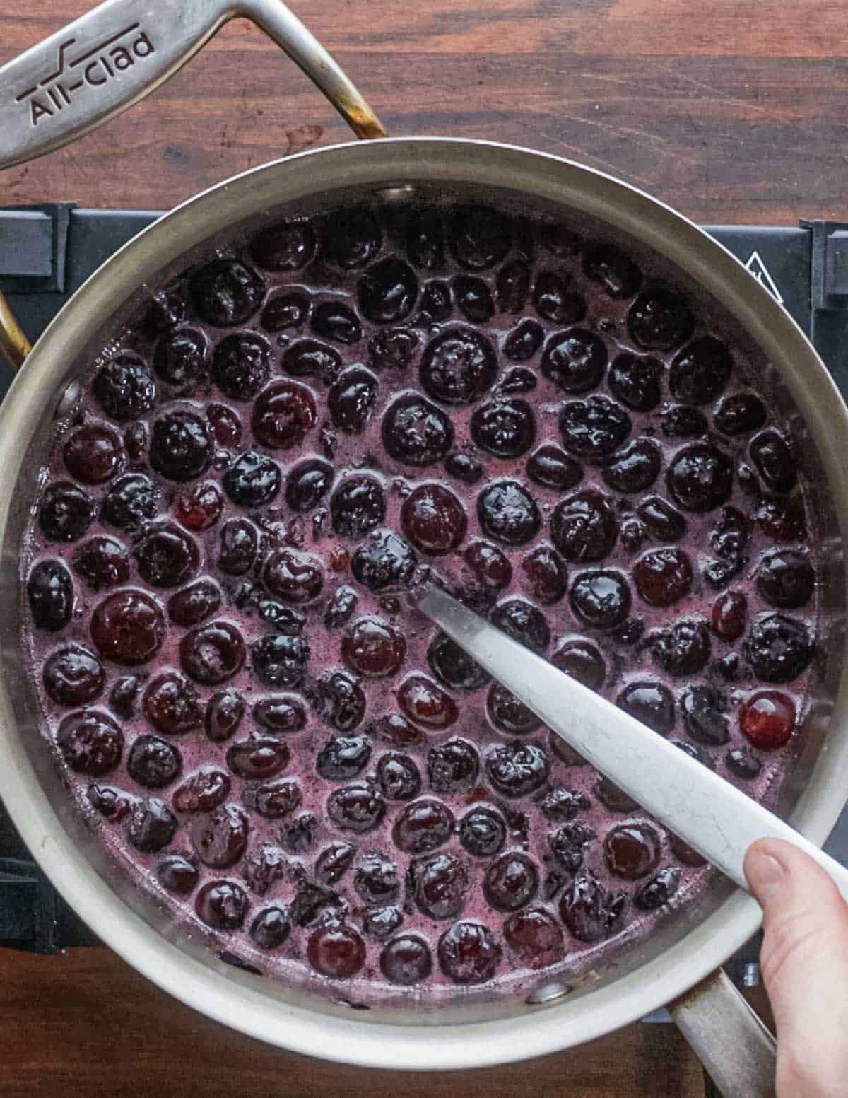 A pan of blueberries in syrup being cooked.