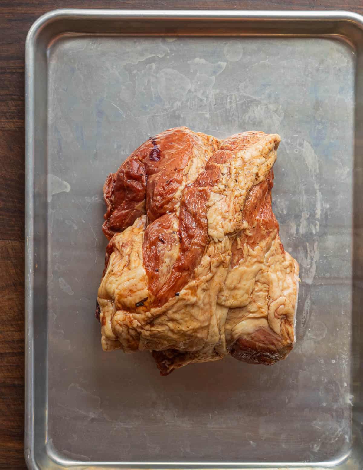 A smoked ham hock on a baking sheet. 
