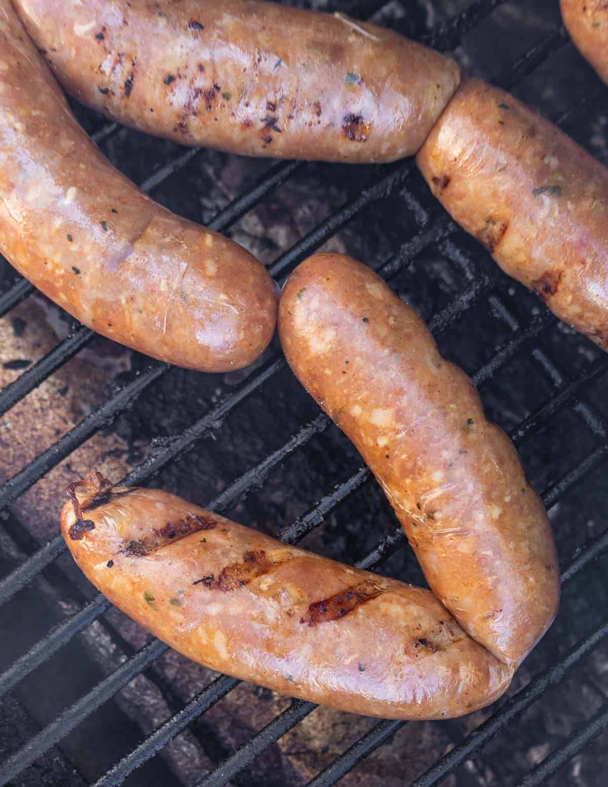 Smoking chicken andouille sausage in a pellet grill smoker. 