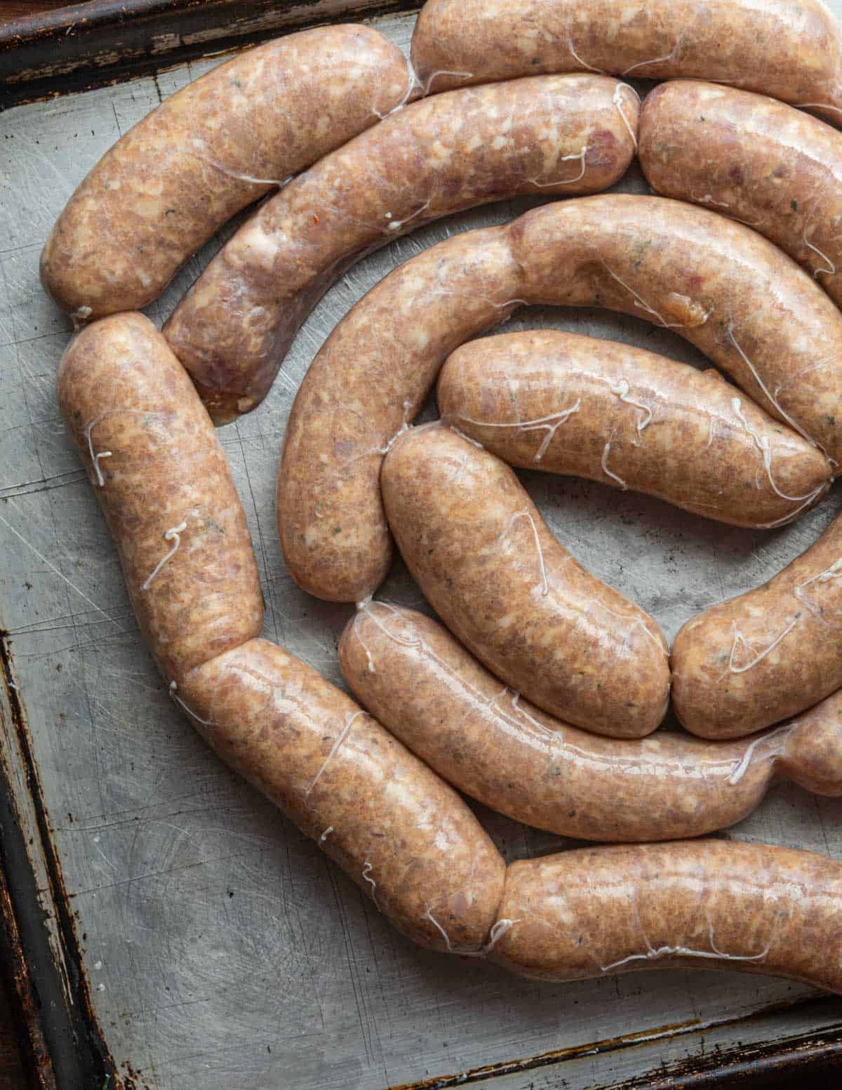 Chicken sausage being twisted into links for smoking. 