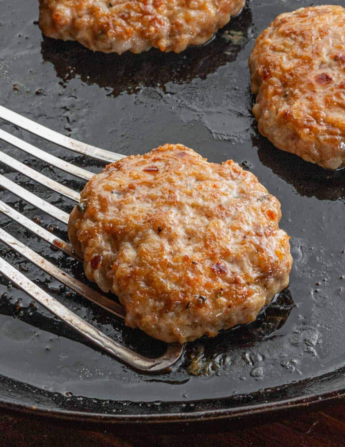 Cooking a test patty of chicken andouille sausage to test the flavor. 