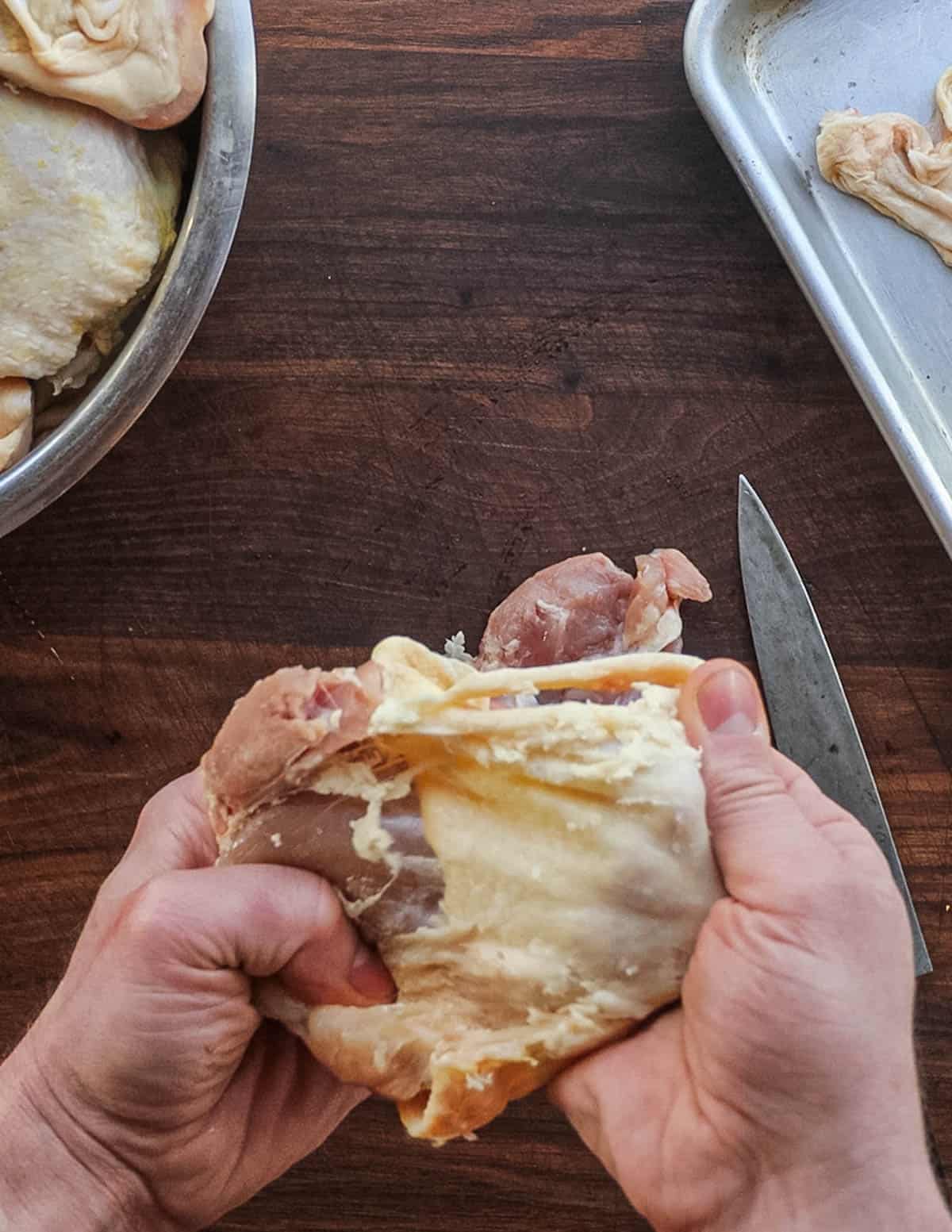 Removing skin from chicken thighs. 