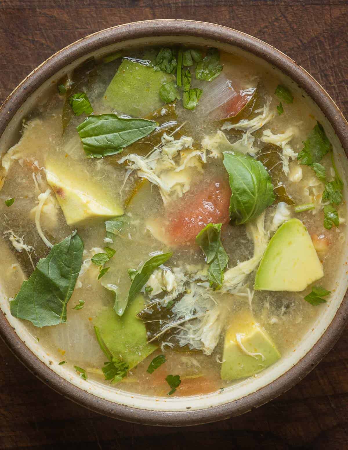 Sopa de mora or sopa de quelites garnished with basil leaves and cilantro.