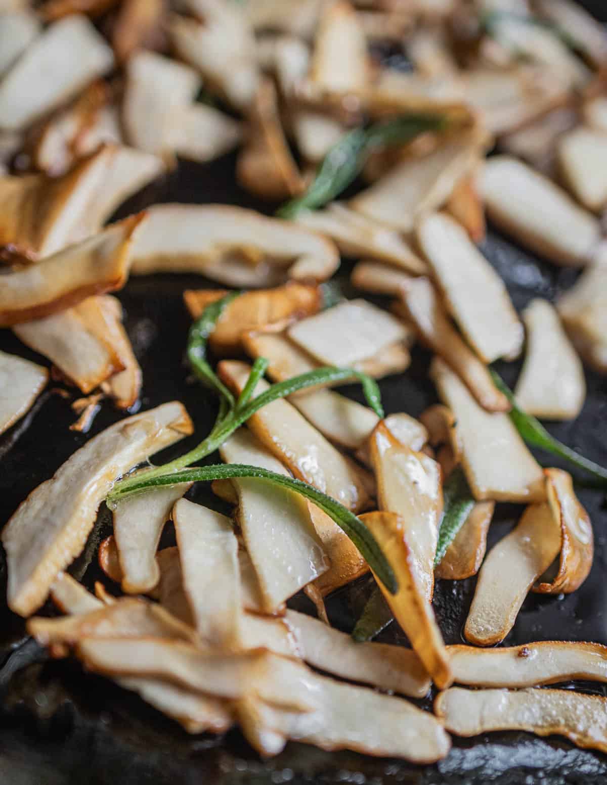 sauteed berkeley's polypore in a pan with sprigs of rosemary. 