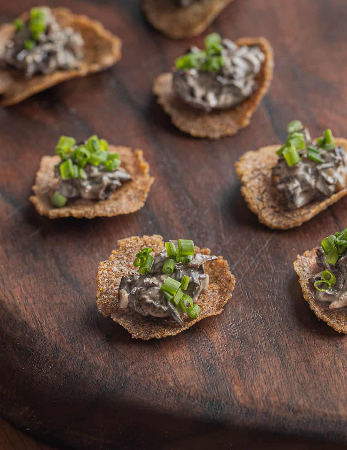 A sour cream mushroom caviar appetizer on wild rice crackers made with black staining polypore mushrooms. 