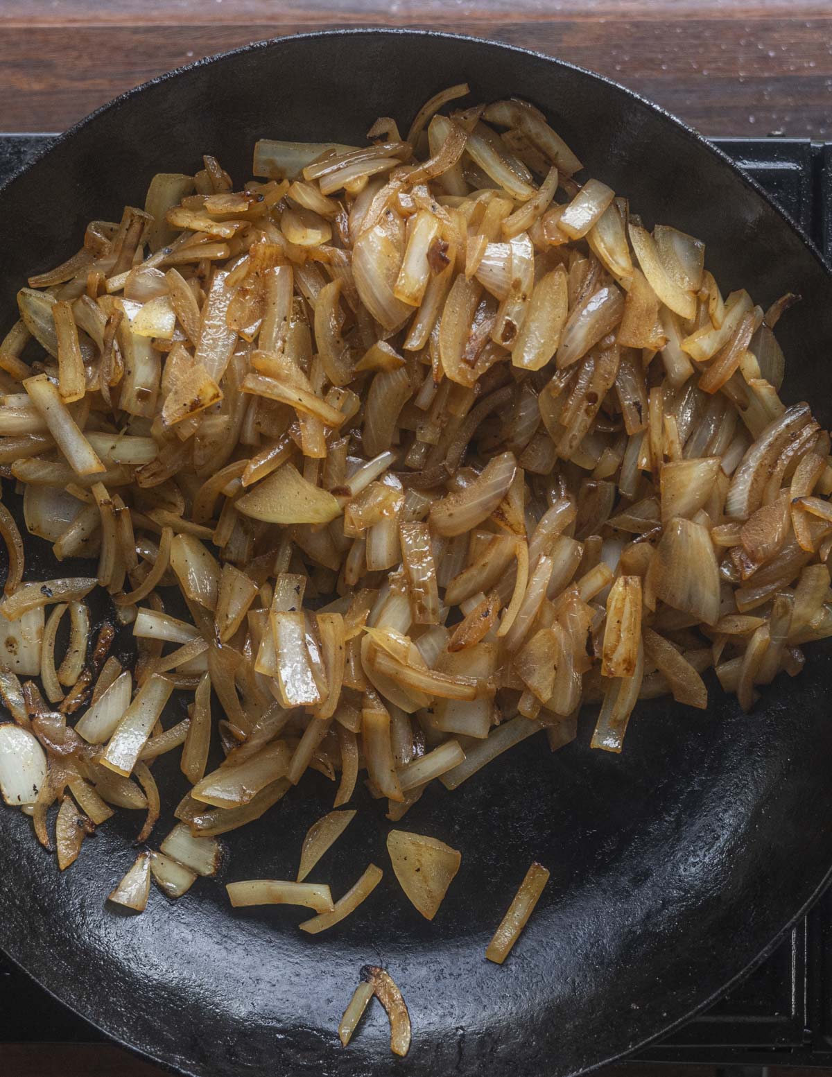 A pan of onions caramelizing and turning golden brown. 