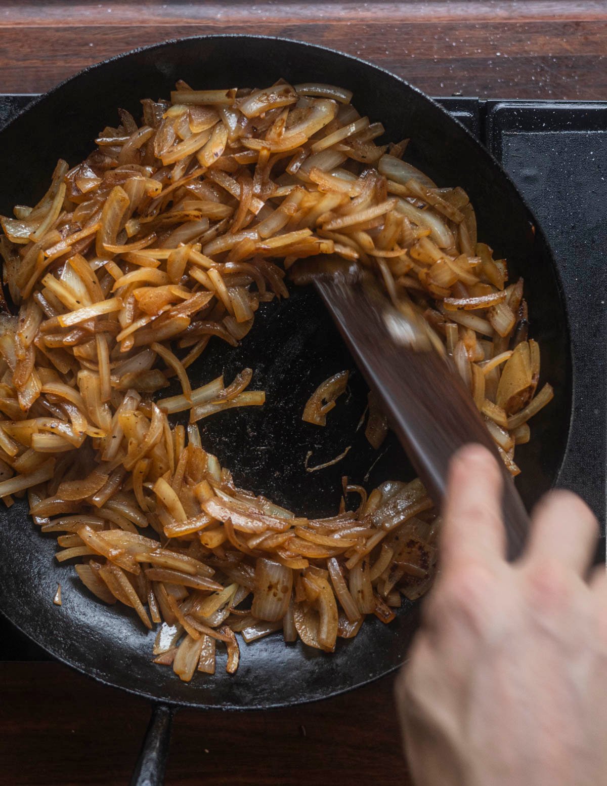 Stirring caramelizing onions vigorously after adding water. 