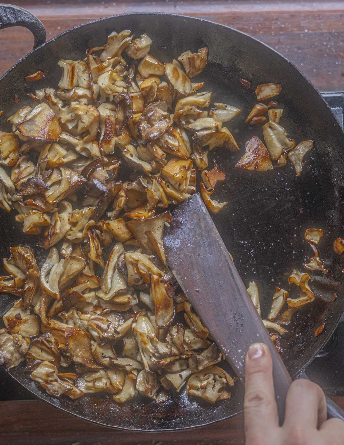 Browning a pan of mushrooms after par cooking them. 