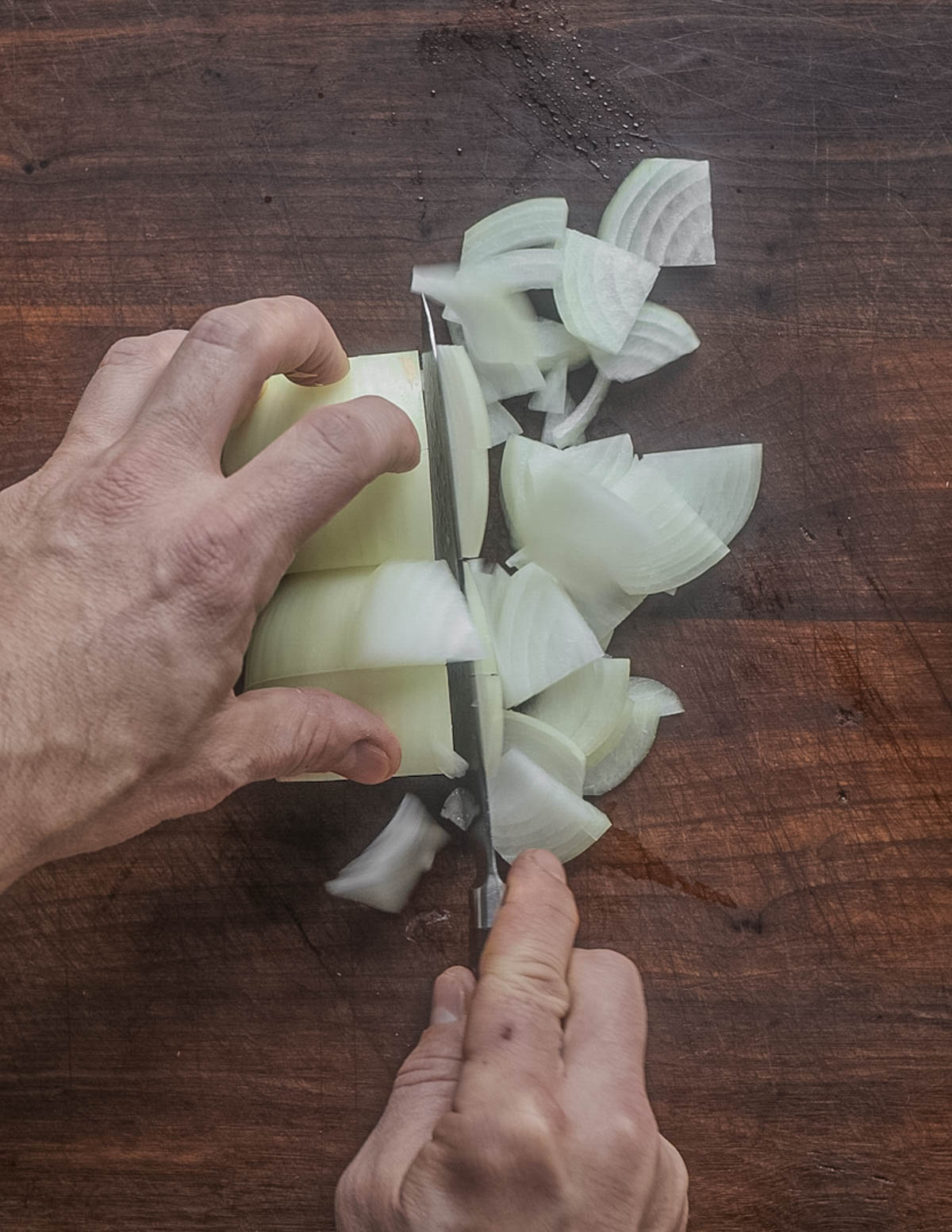 Thinly slicing onions to make caramelized onions. 