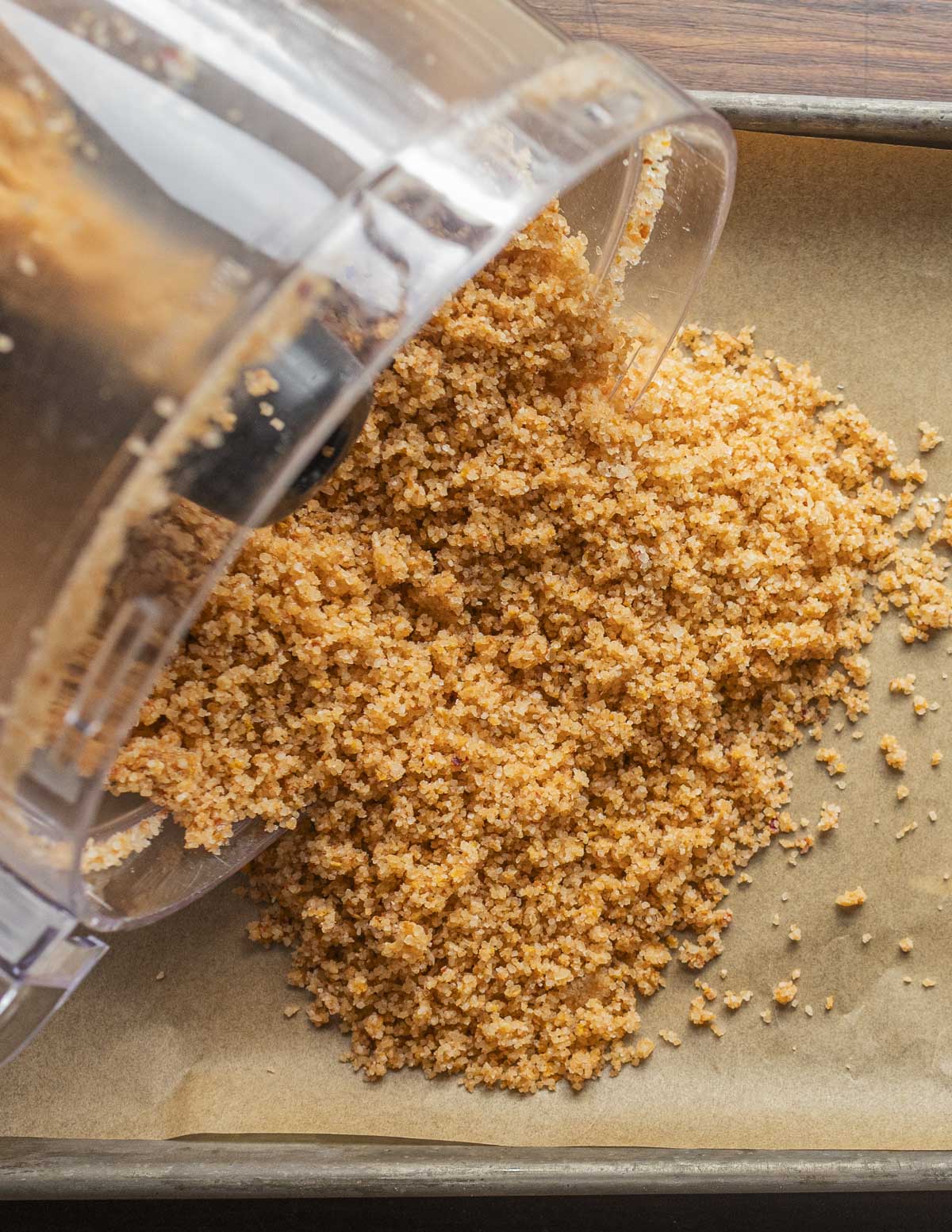 Spreading hot chili pepper salt onto a baking sheet lined with parchment. 