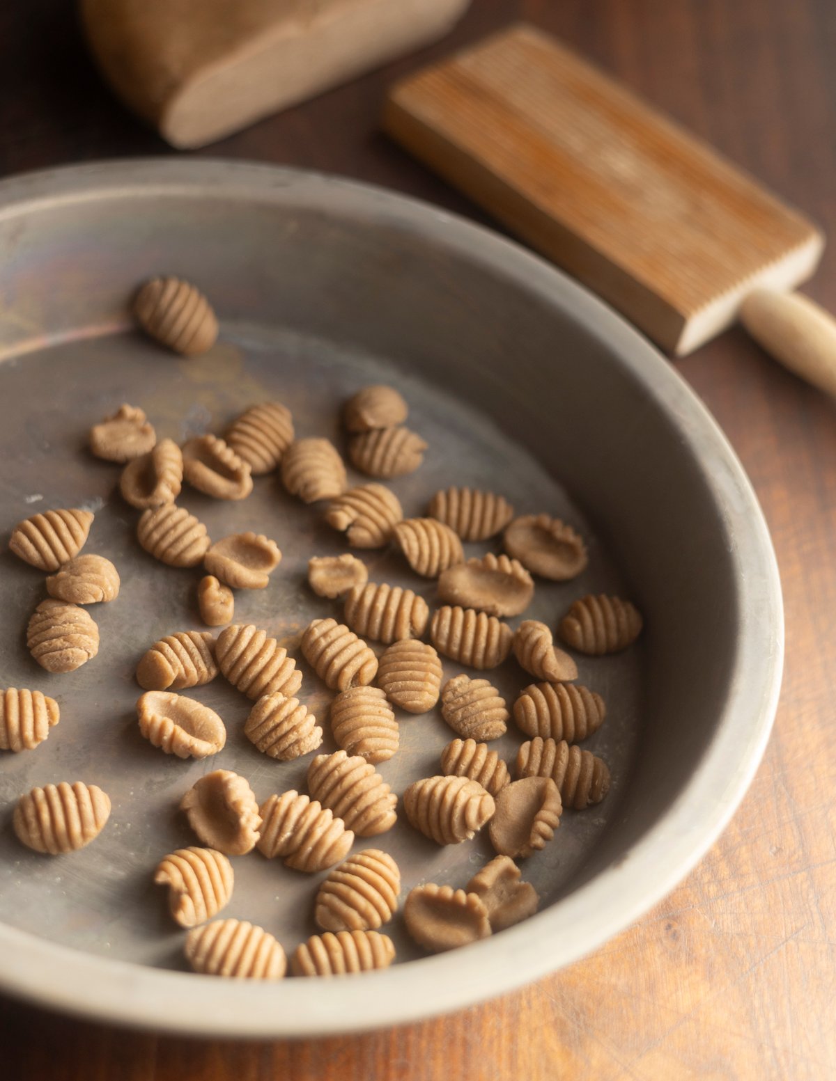 A pie plate filled with homemade chestnut gnocchi.