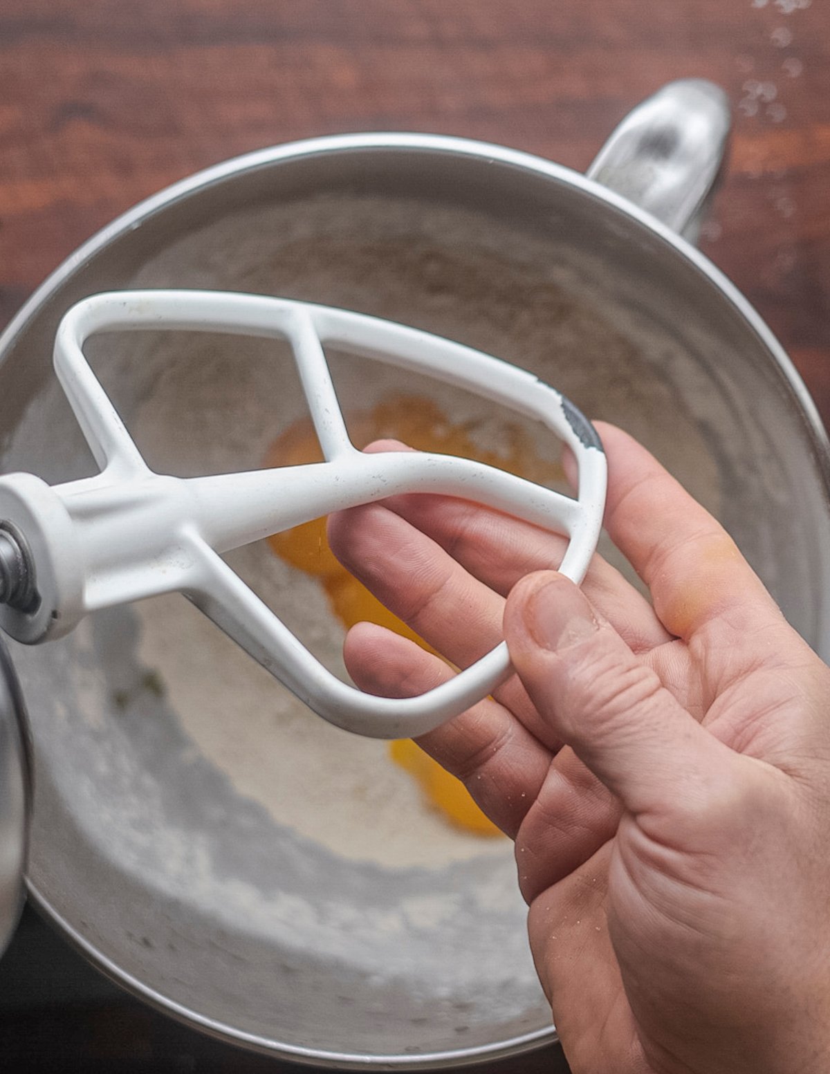 Mixing chestnut flour pasta dough with the paddle attachment of a stand mixer.