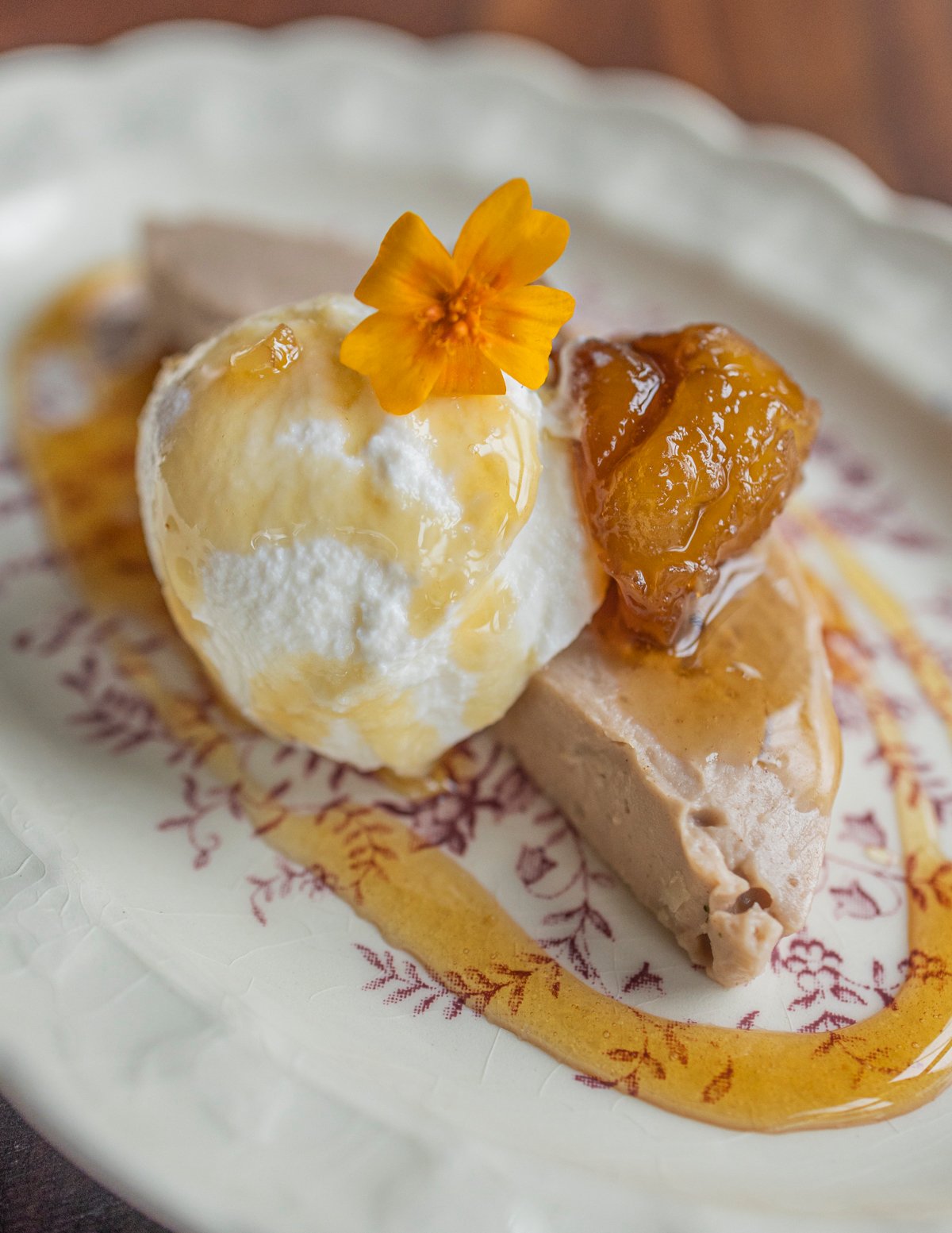 A slice of chestnut polenta or polenta di castagne served with ricotta cheese and chestnut honey.