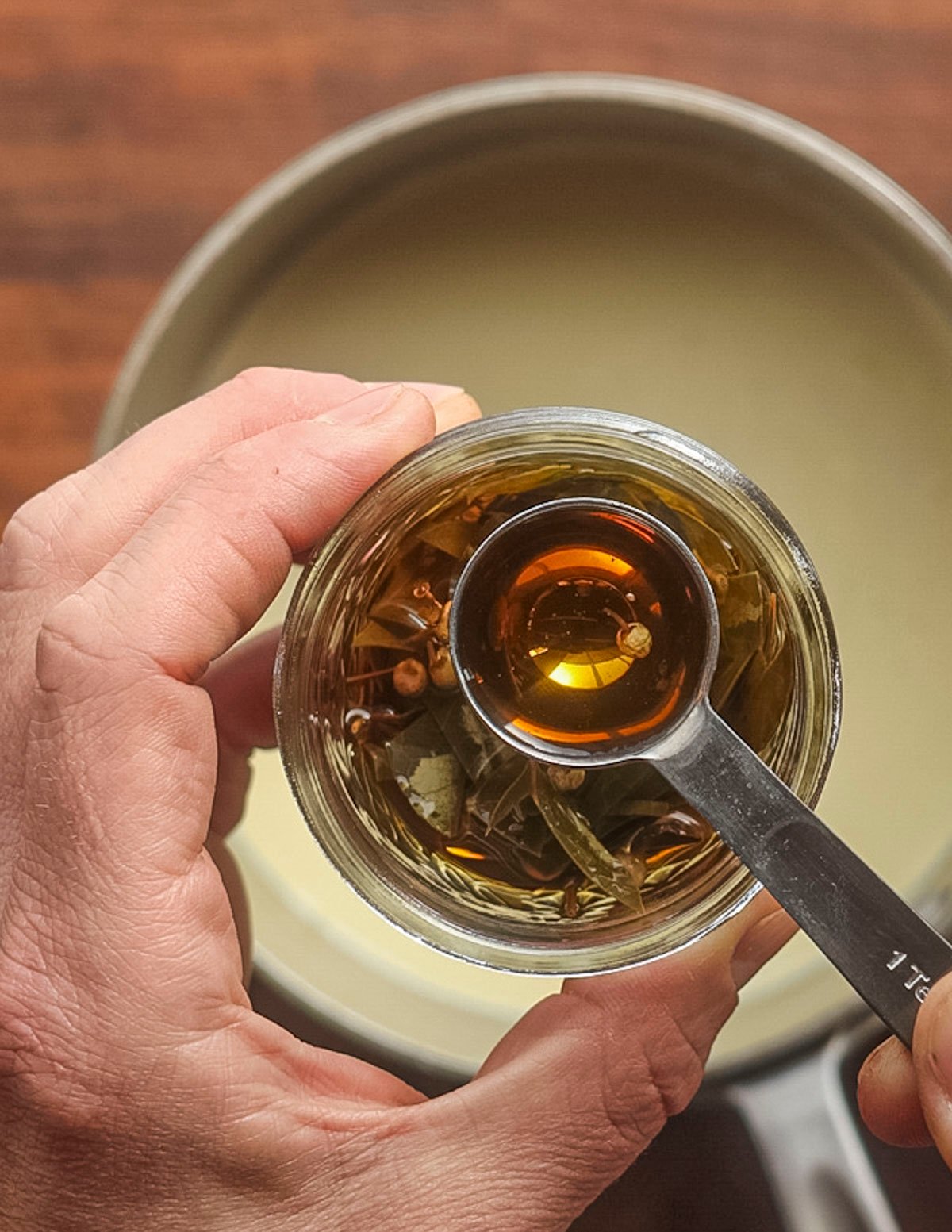 Adding a spoonful of wintergreen extract to an ice cream base. 