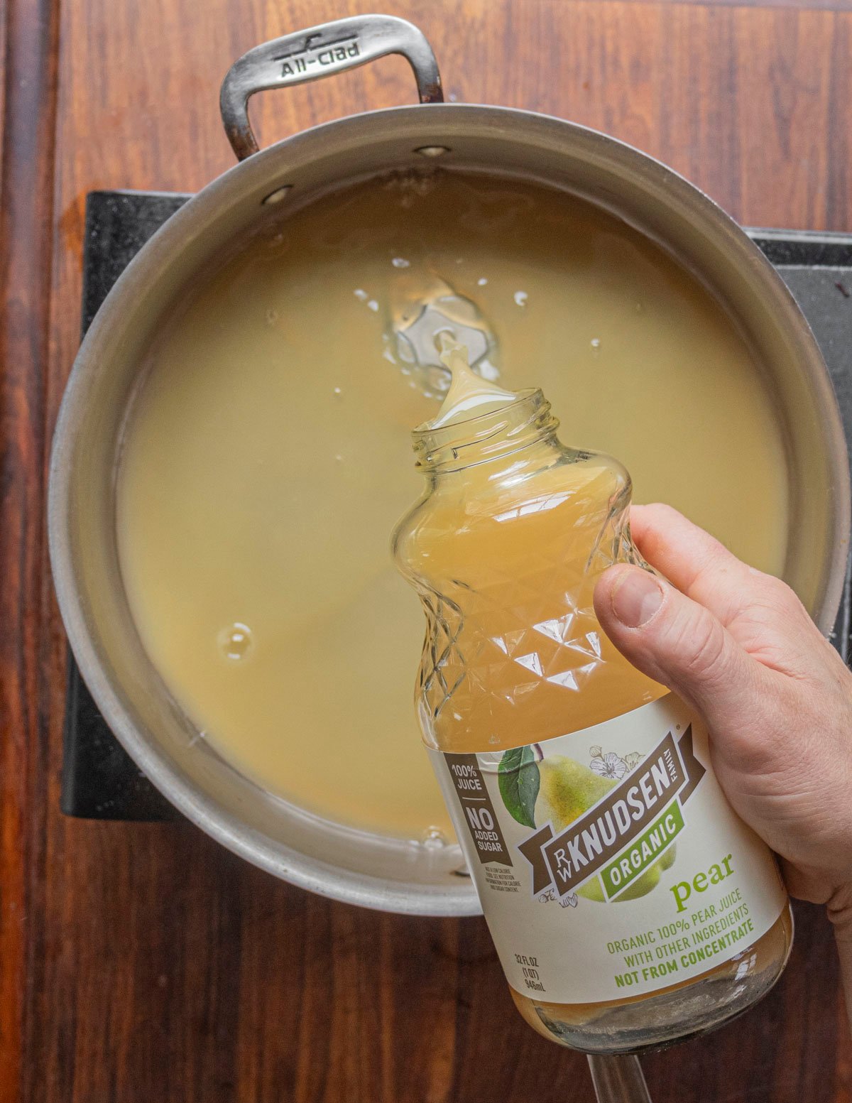 Pouring pear juice into a pan. 