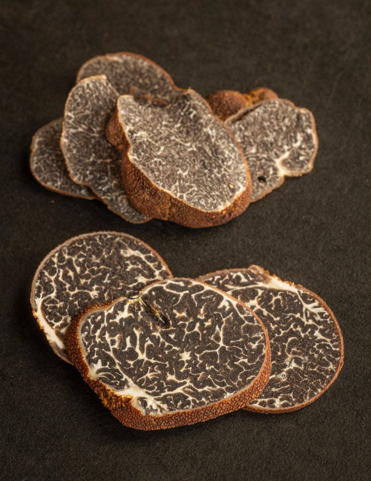 Sliced Appalachian truffles (Tuber canaliculatum) showing the internal white marbled spore material or gleba. 