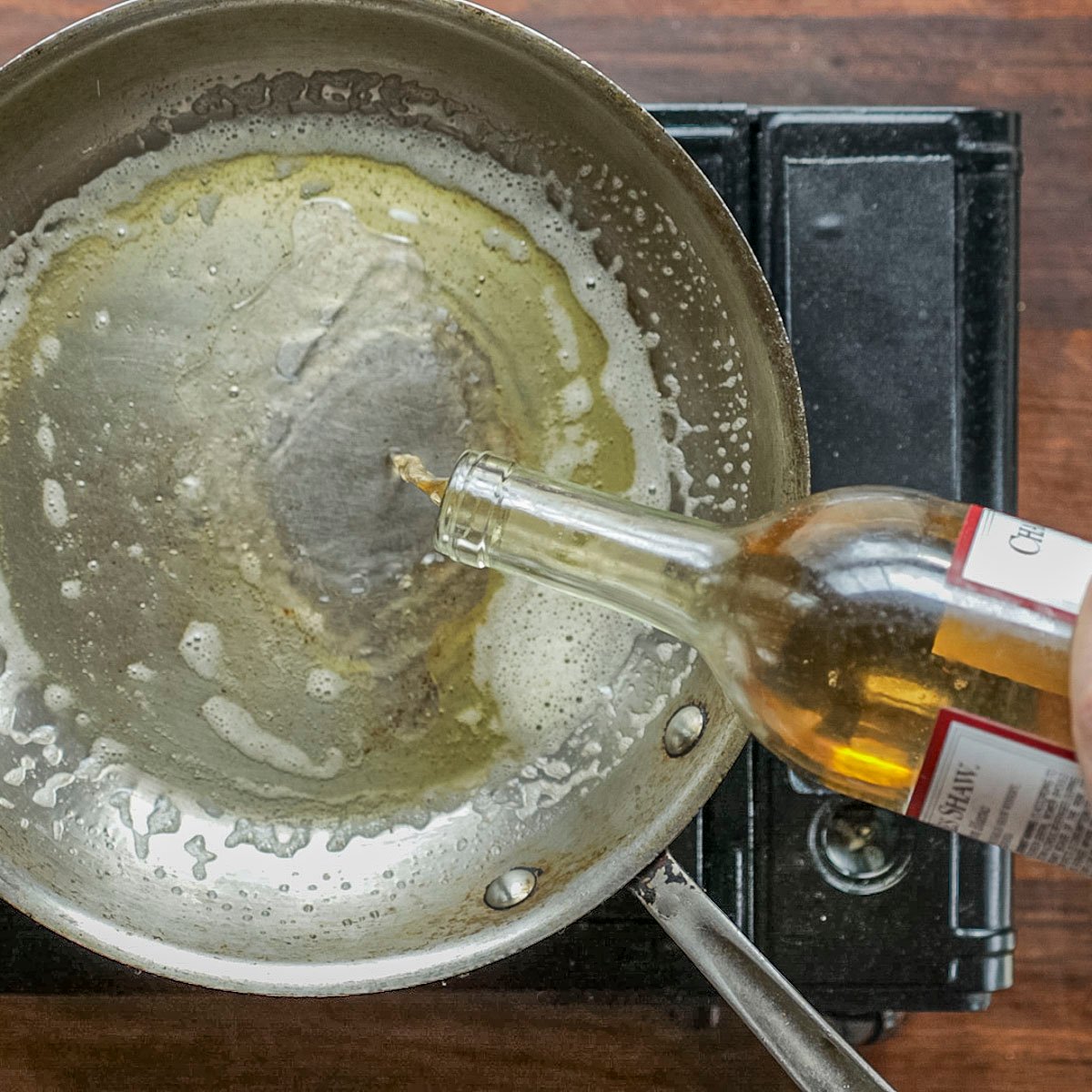 Deglazing a pan of brown butter with white wine. 