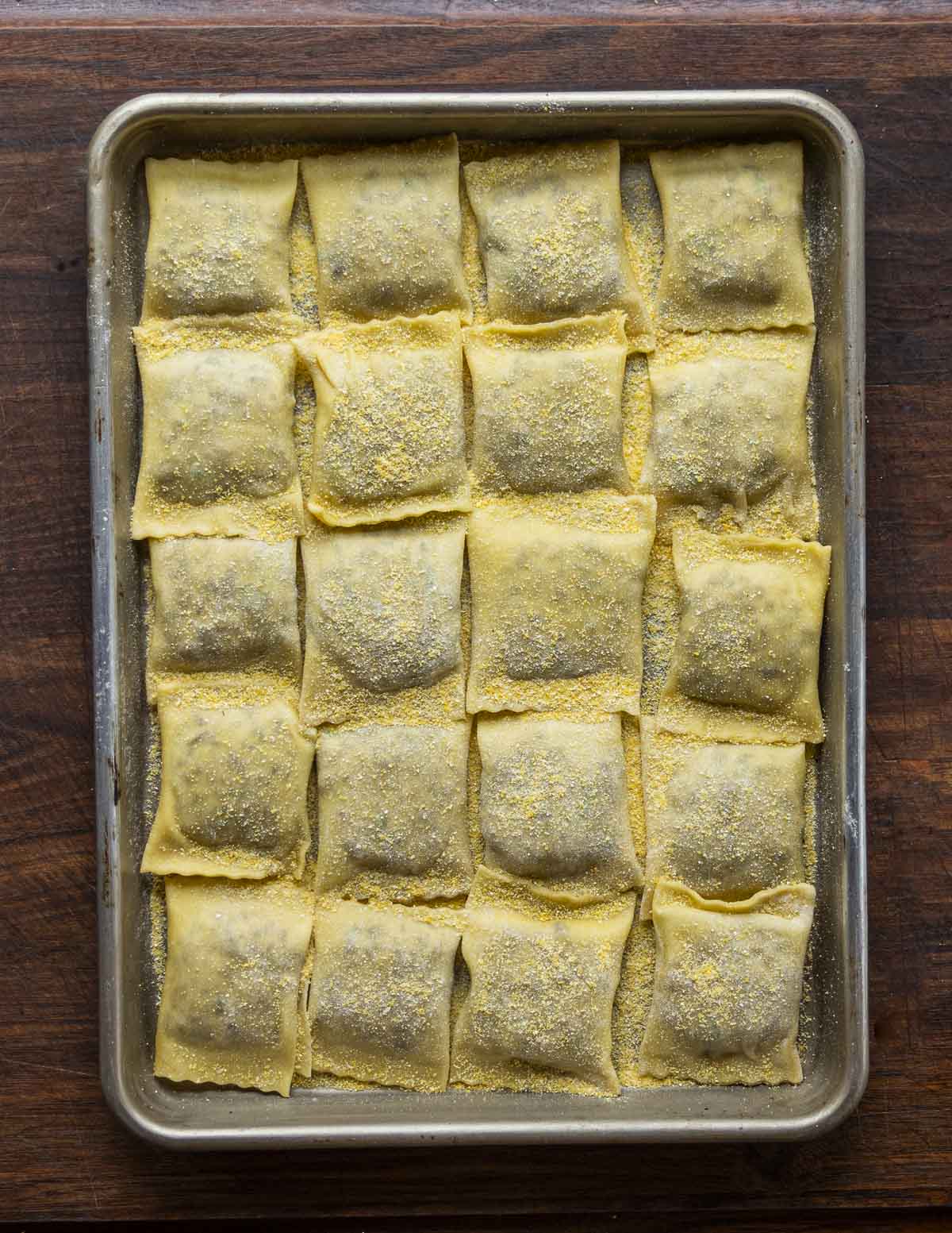 Finished, portioned ravioli on a baking sheet. 