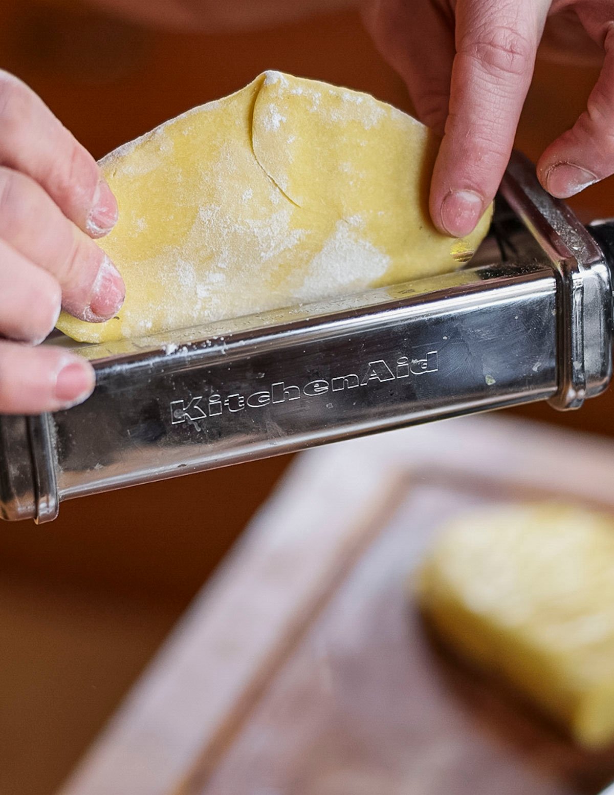 Rolling out fresh ravioli dough using a Kitchen Aid pasta attachment. 