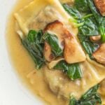 Cooked porcini ravioli in a brown butter sauce with spinach and sauteed fresh porcini mushrooms.