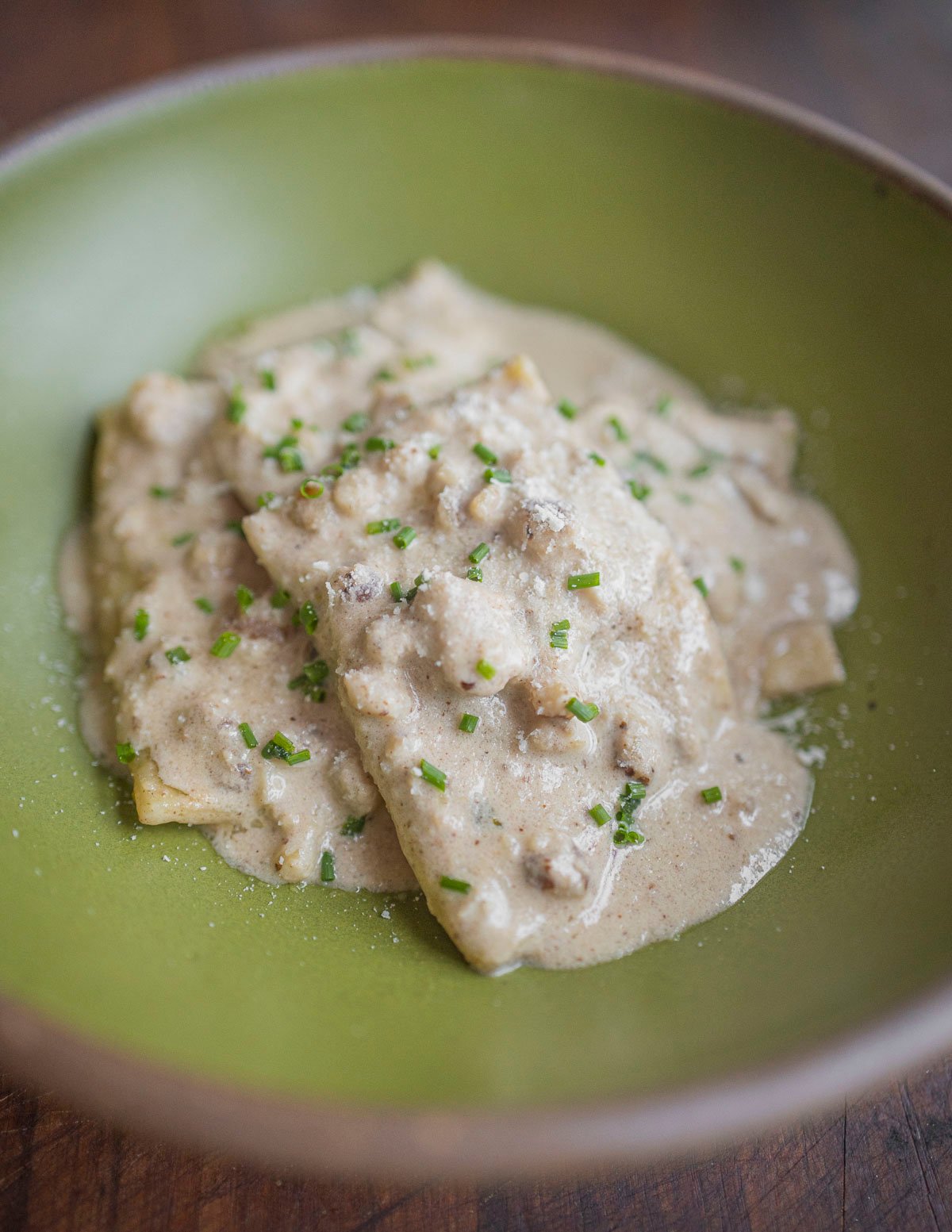 Freshly cooked ravioli in a black walnut salsa di noci. 