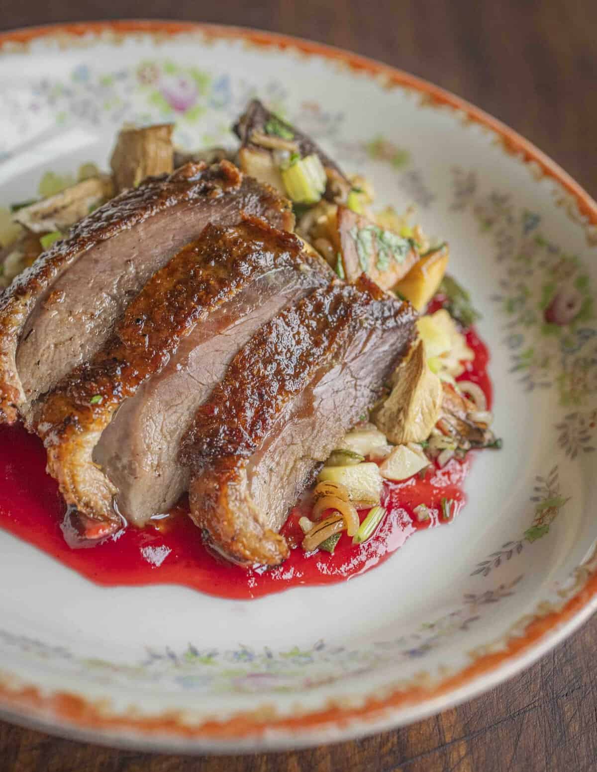 Sliced roasted goose with highbush cranberry sauce, wild rice and butternuts or white walnuts.