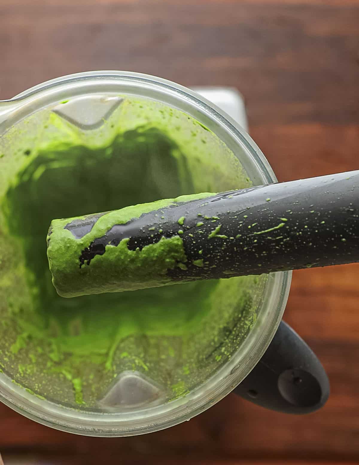 A blender full of fresh spinach puree. 