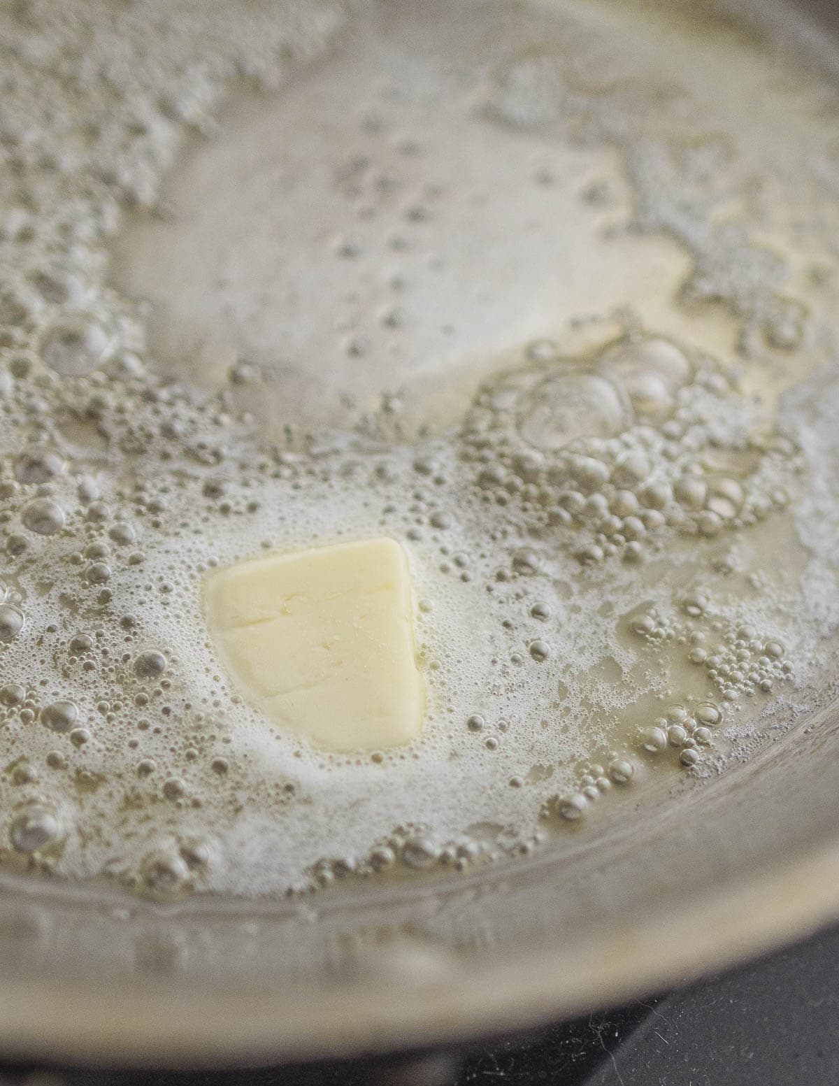 Cooking unsalted butter in a pan to make brown butter. 