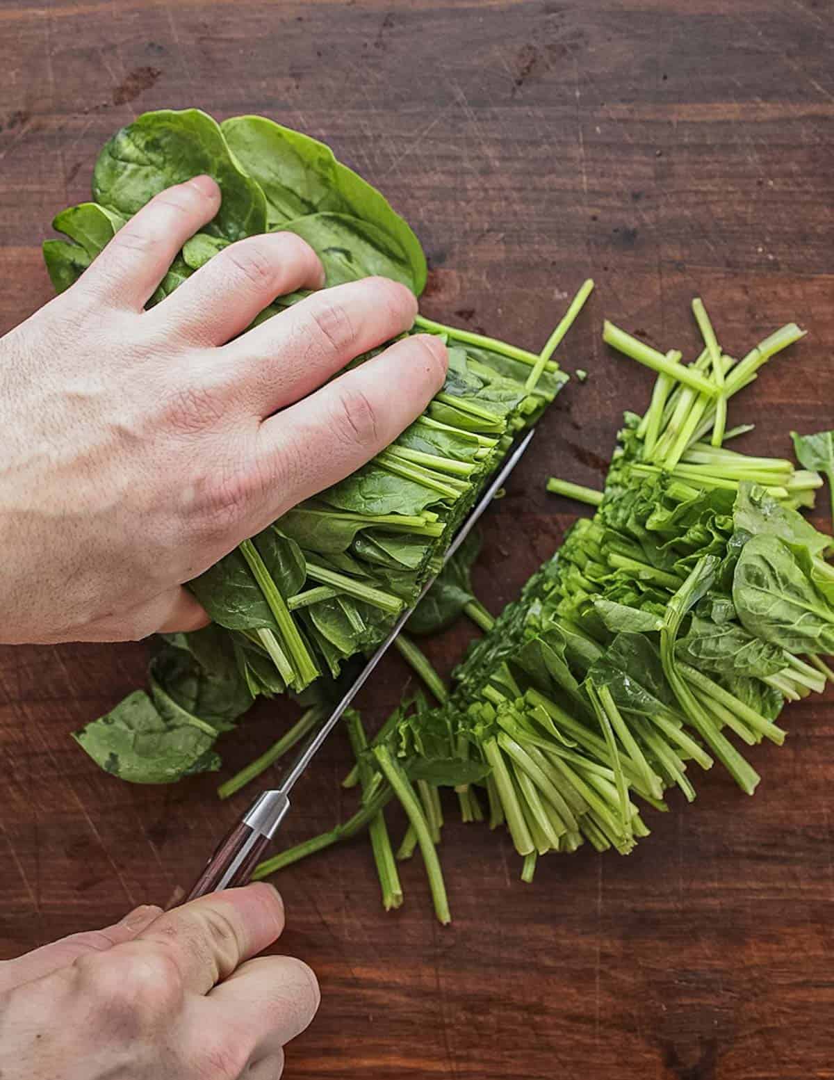 Removing the stems from spinach leaves. 