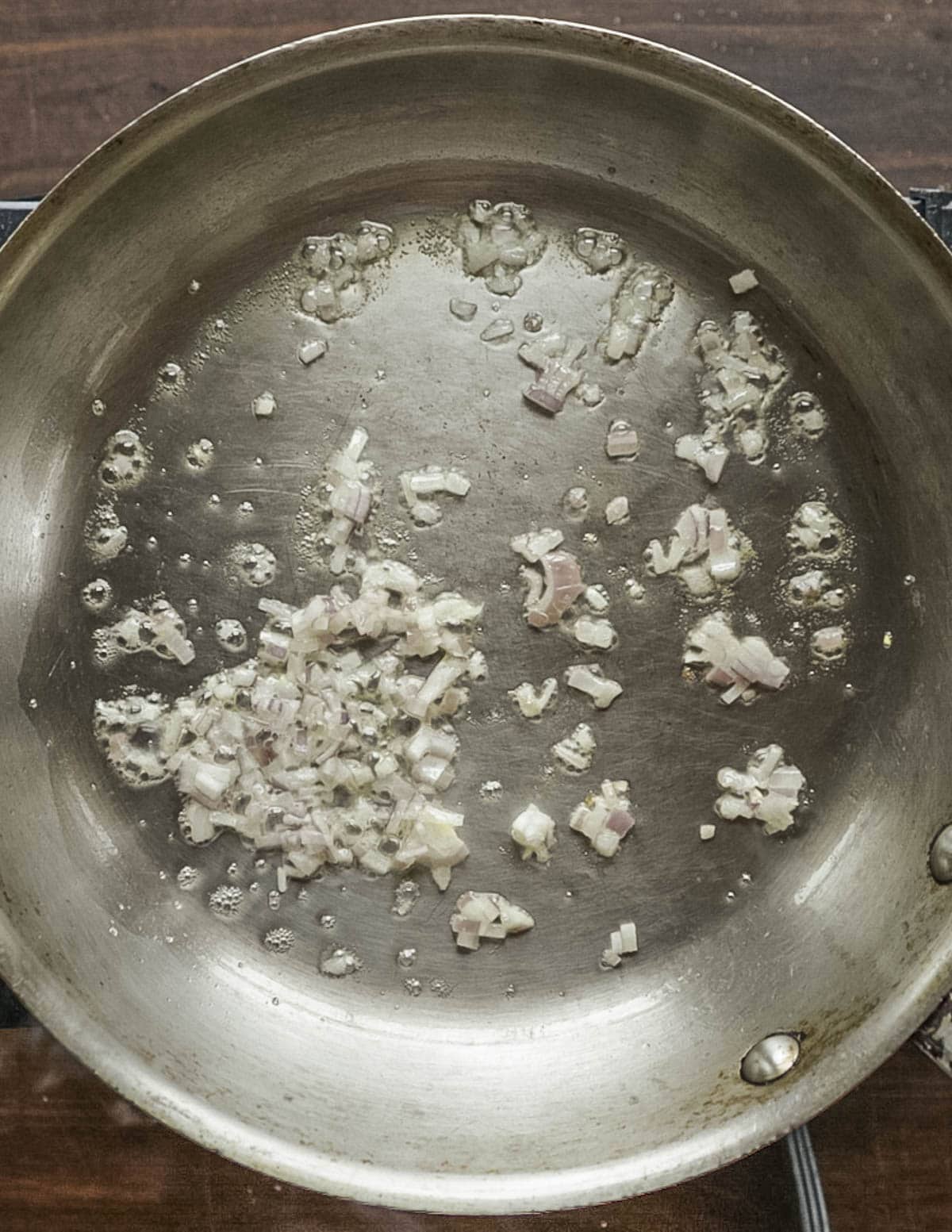 Cooking shallots in a pan with butter. 