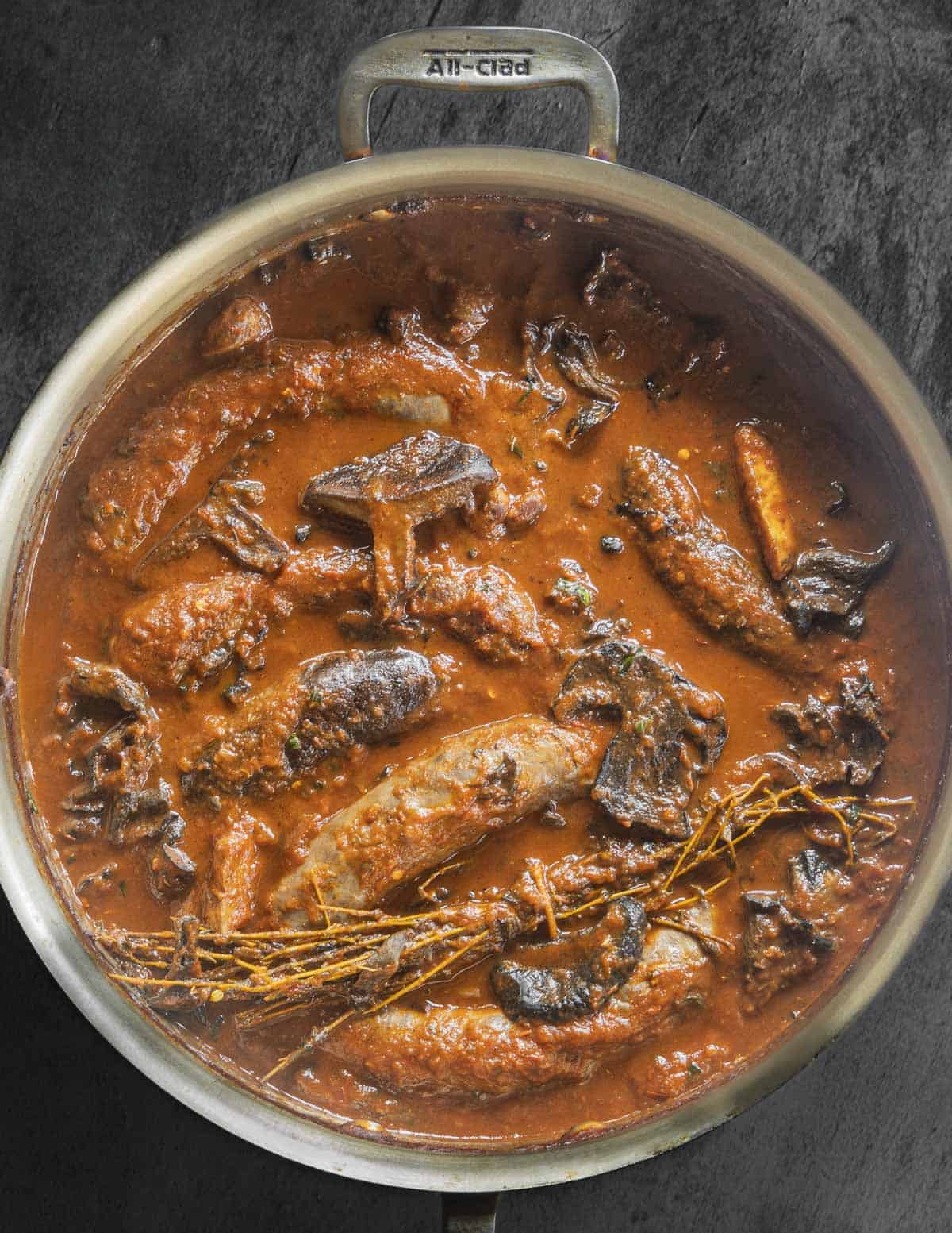 Baked Italian sausages with black velvet bolete mushrooms and milk cap mushrooms. 