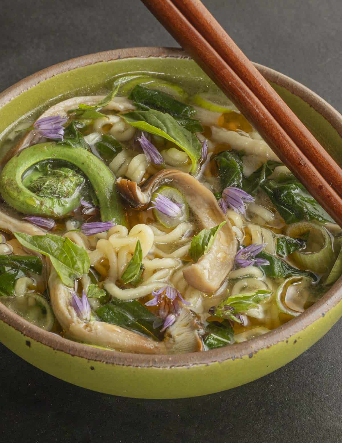 Pioppino mushroom ramen noodle soup with fiddlehead ferns, cow parsnip shoots and thai basil. 