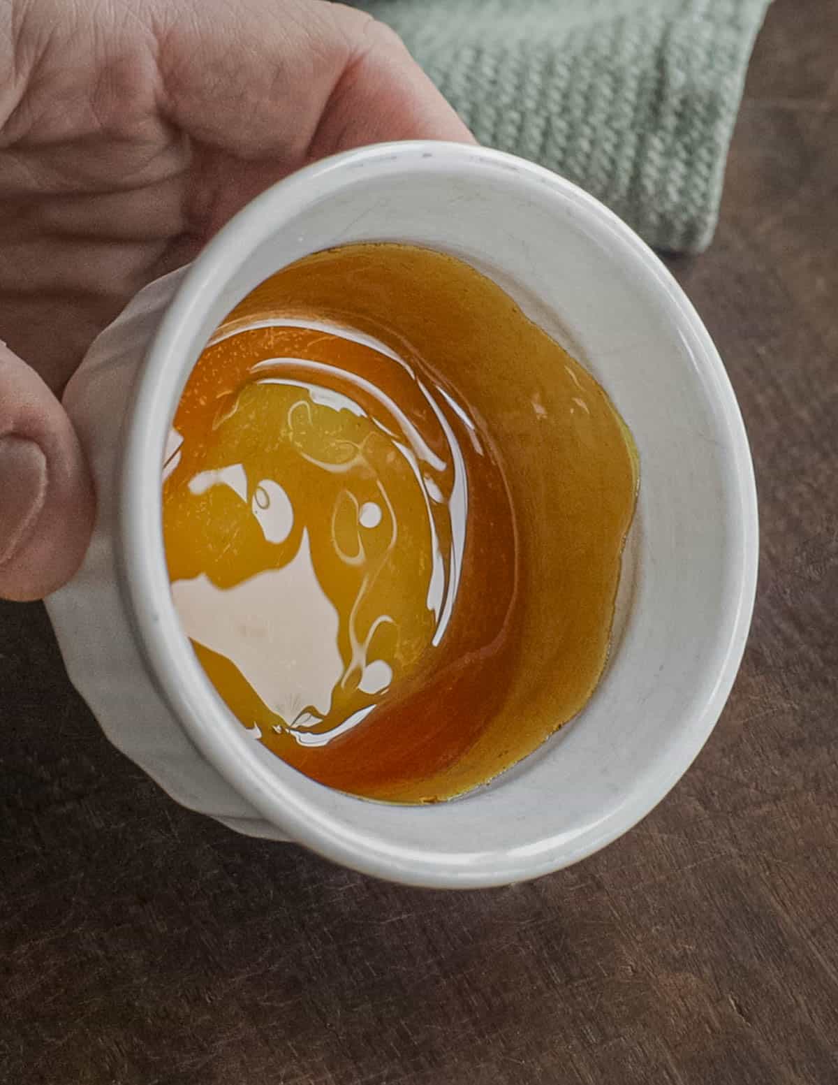 Lining a ramekin mold with caramel.