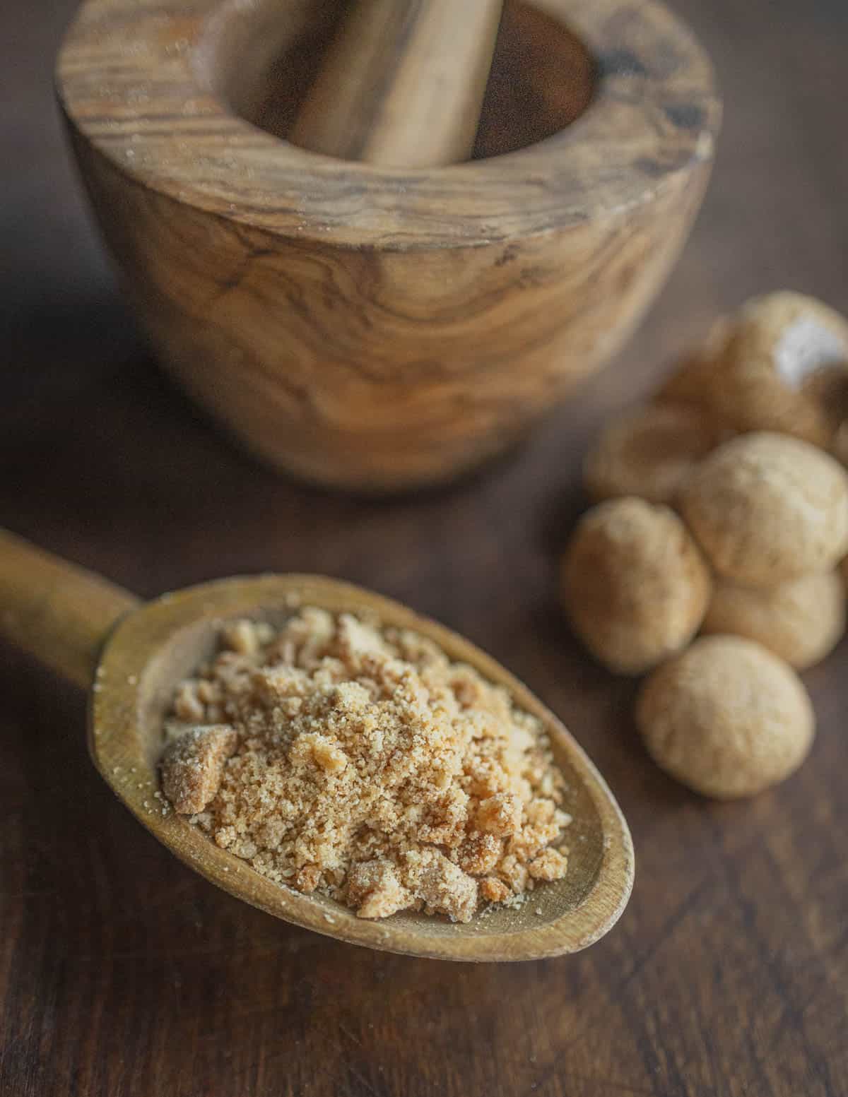 Crushing amaretti cookies with a moratr and pestle. 