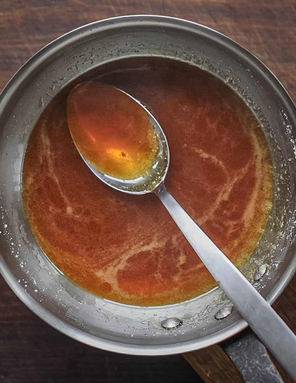 A pan of finished caramel sauce ready to line custard or flan molds. 