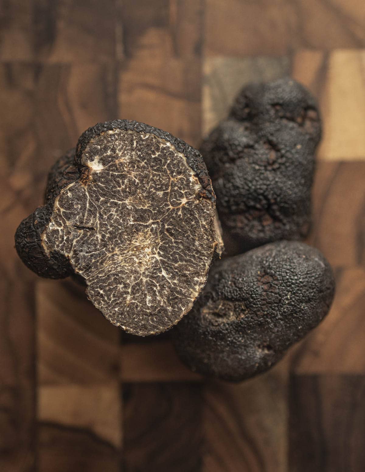 Whole tuber macrosporum truffles sliced to show the inner gleba pattern and defetcs. 