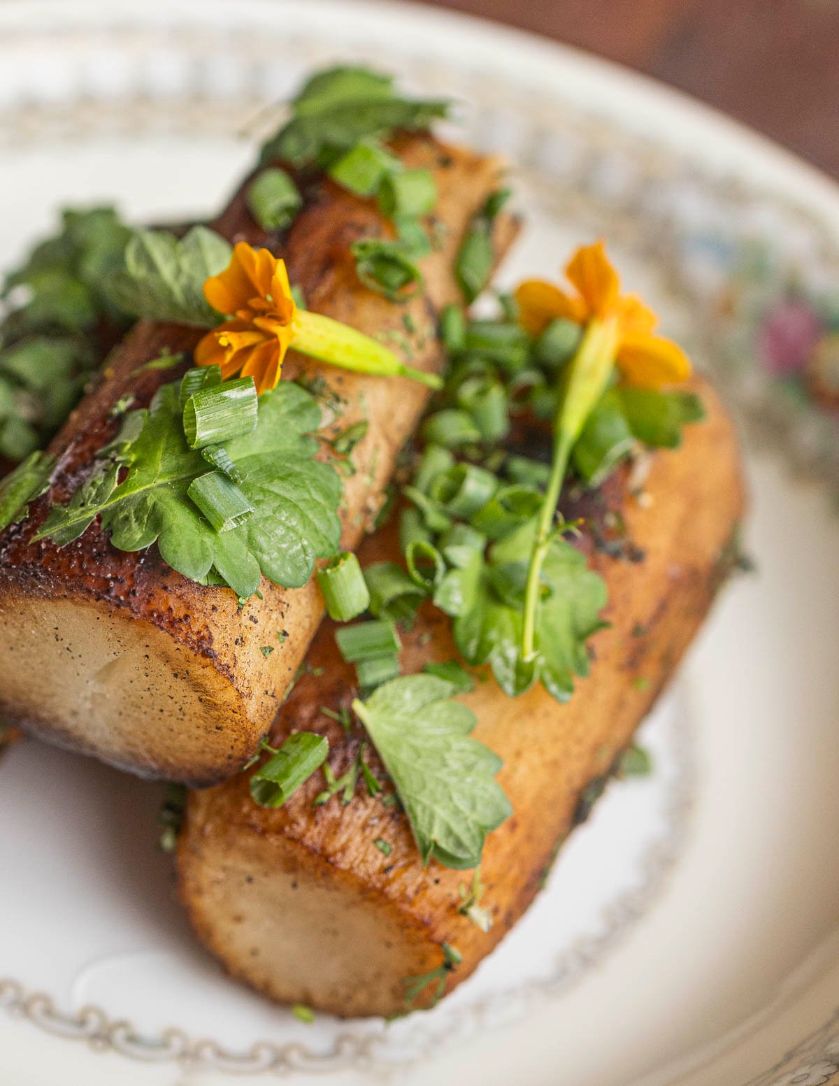 Fried salsify roots on a plate garnished with herbs. 