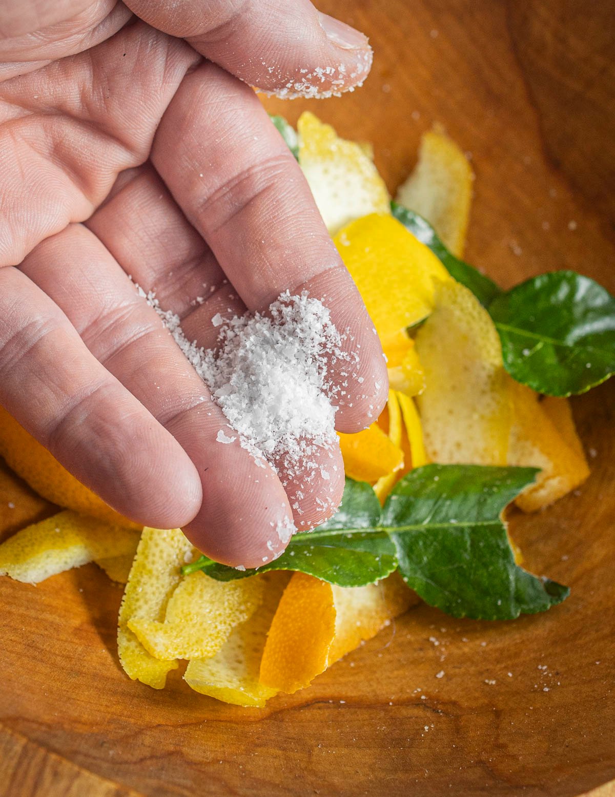 Mixing citrus zest with kosher salt. 