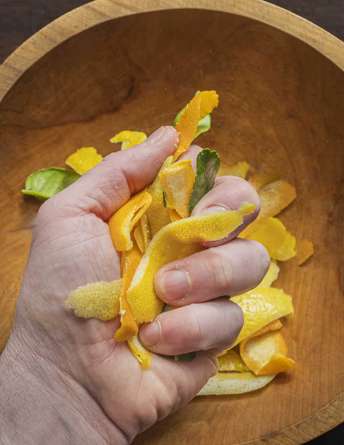 Massaging lemon zest with kosher salt. 