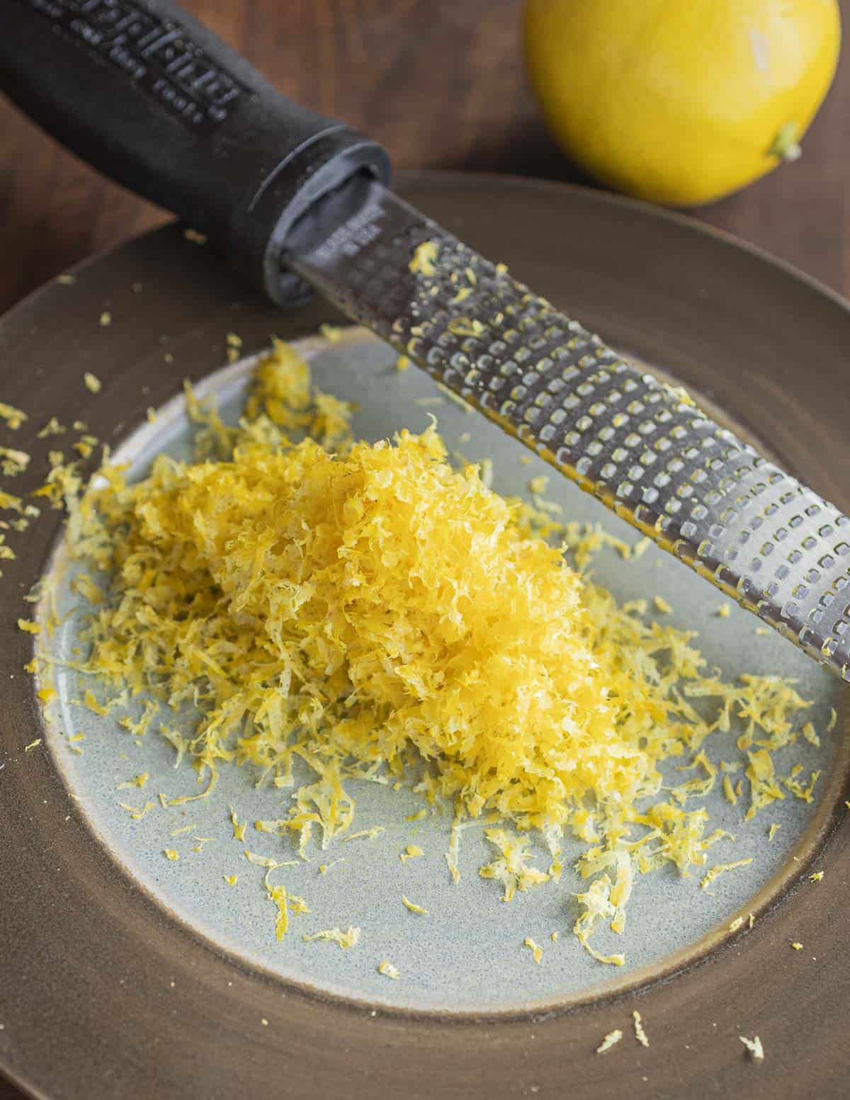 Grating lemon peel with a microplane zester.