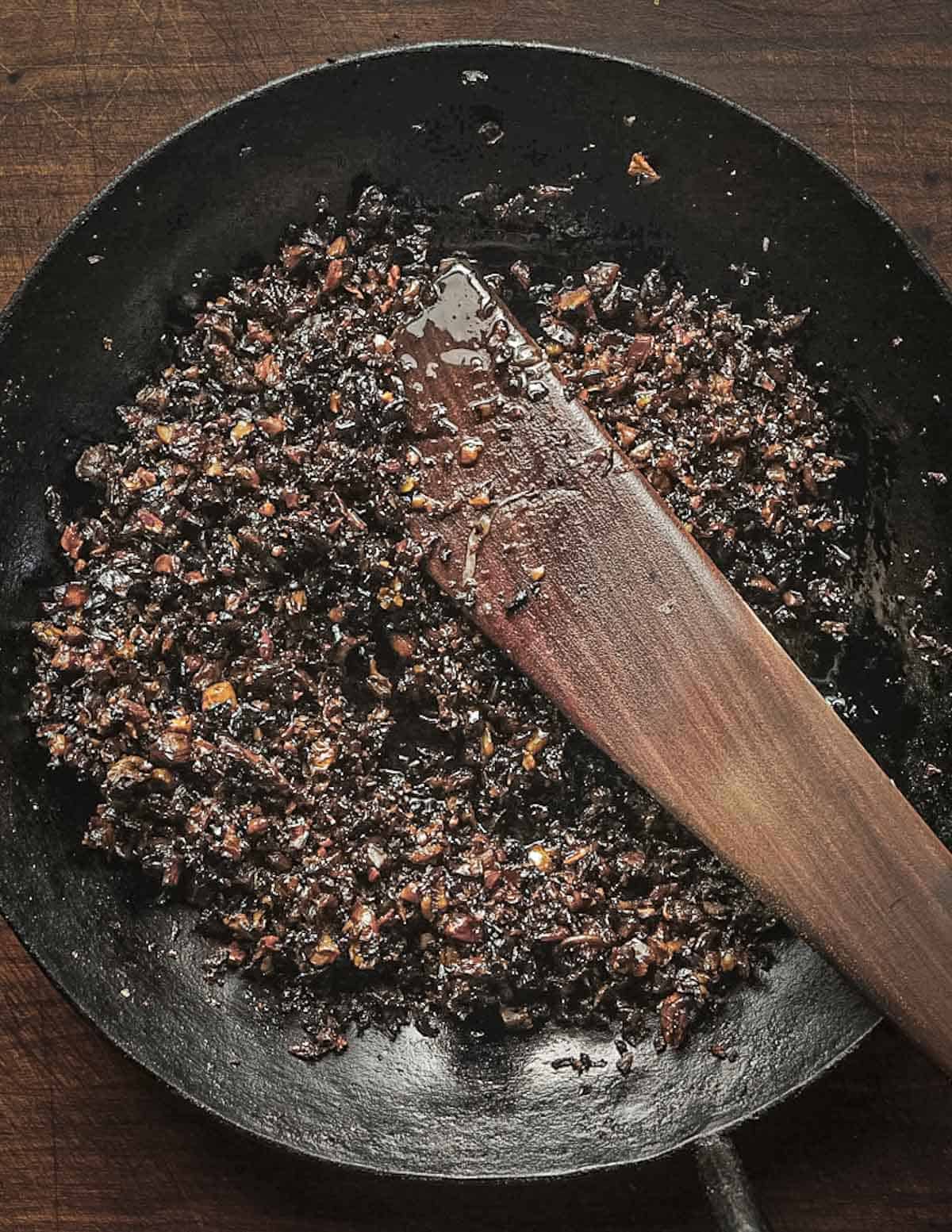 A pan of baked, dried mushrooms that have been caramelized in the oven. 